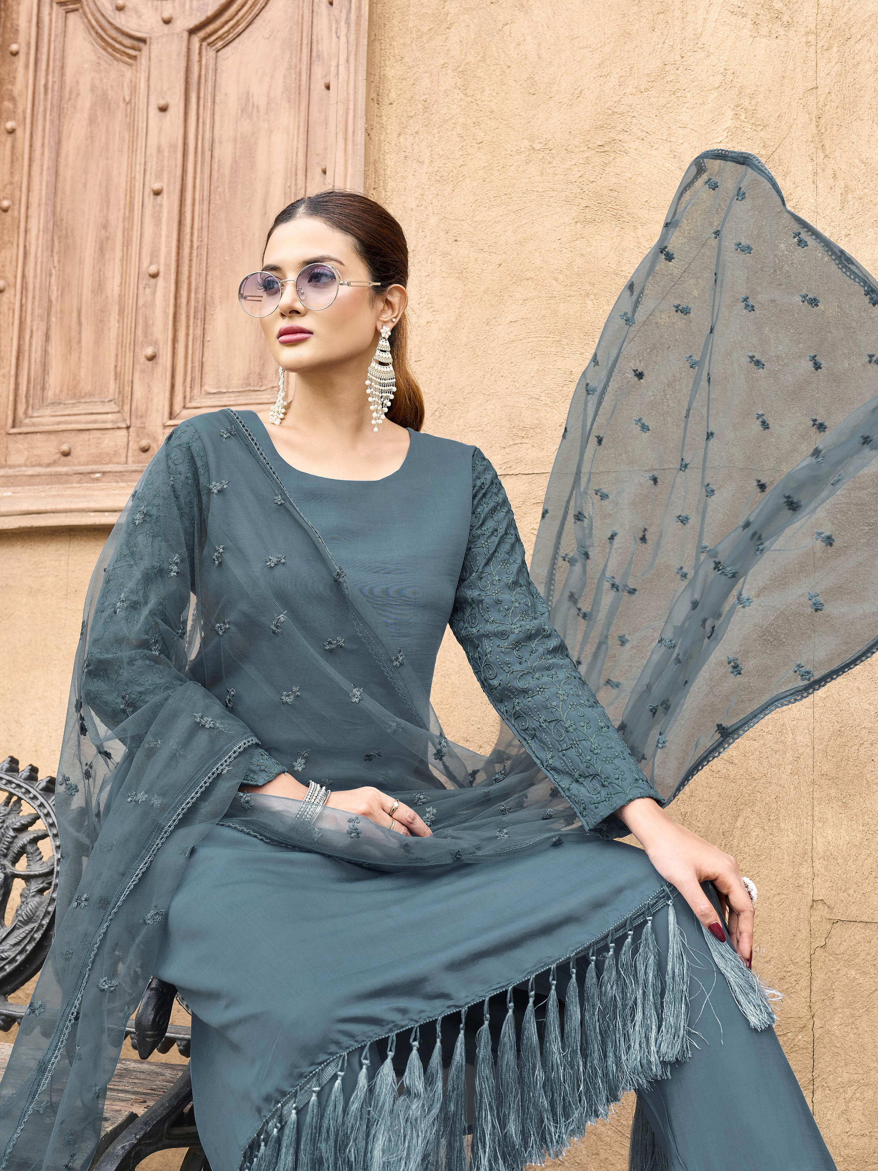 Burnt Blue color silk blend with thread embroidered on sleeves & tassels on heamline kurta & trouser with dupatta set