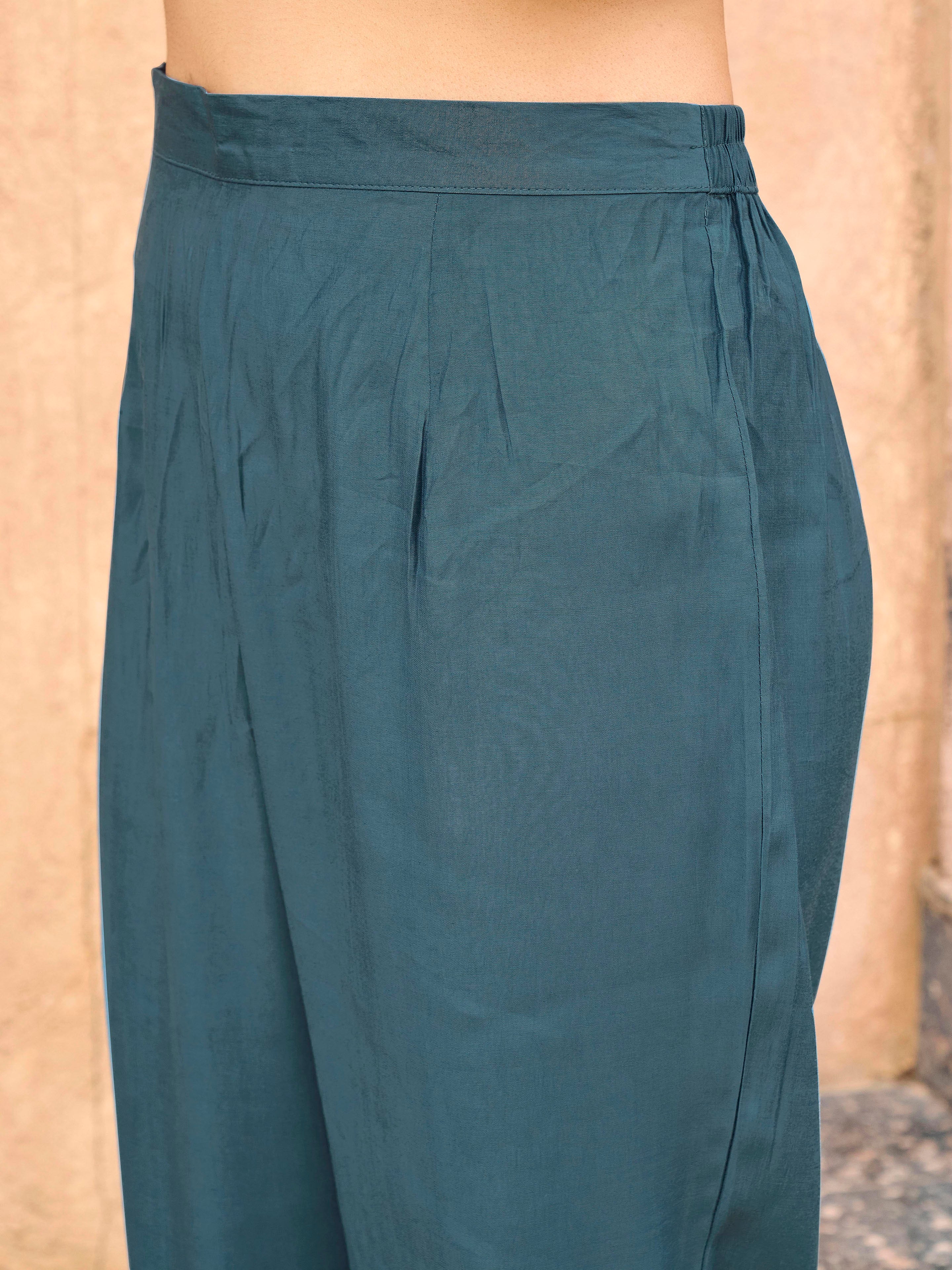 Burnt Blue color silk blend with thread embroidered on sleeves & tassels on heamline kurta & trouser with dupatta set