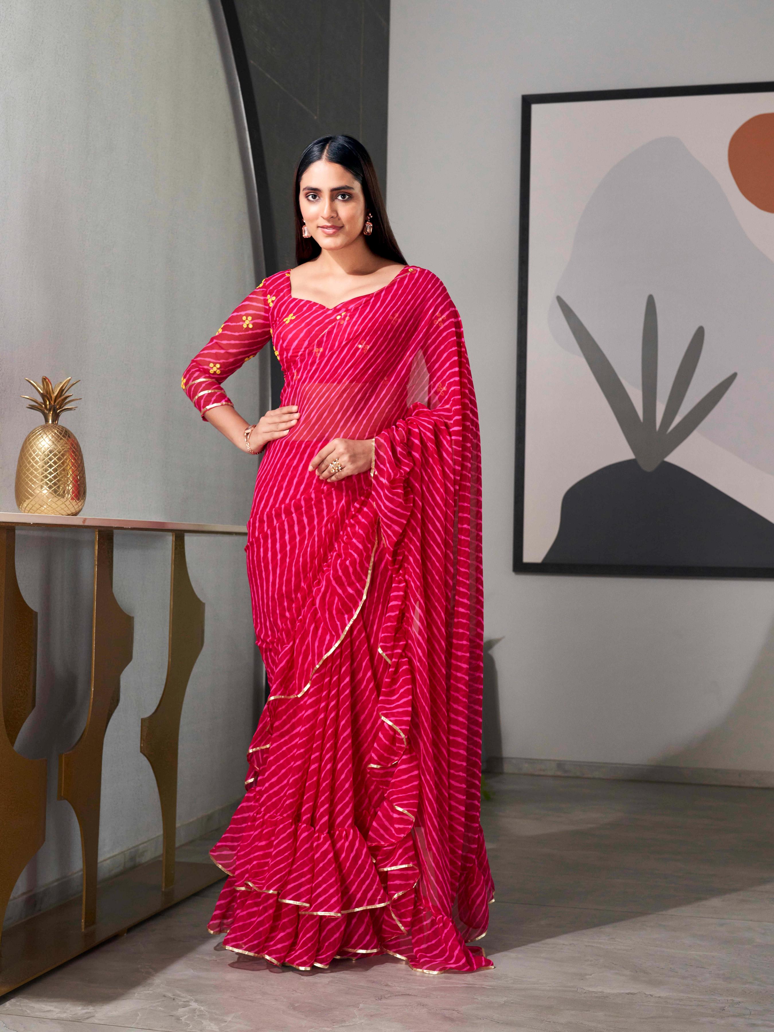Pink colored lehariya saree with frill