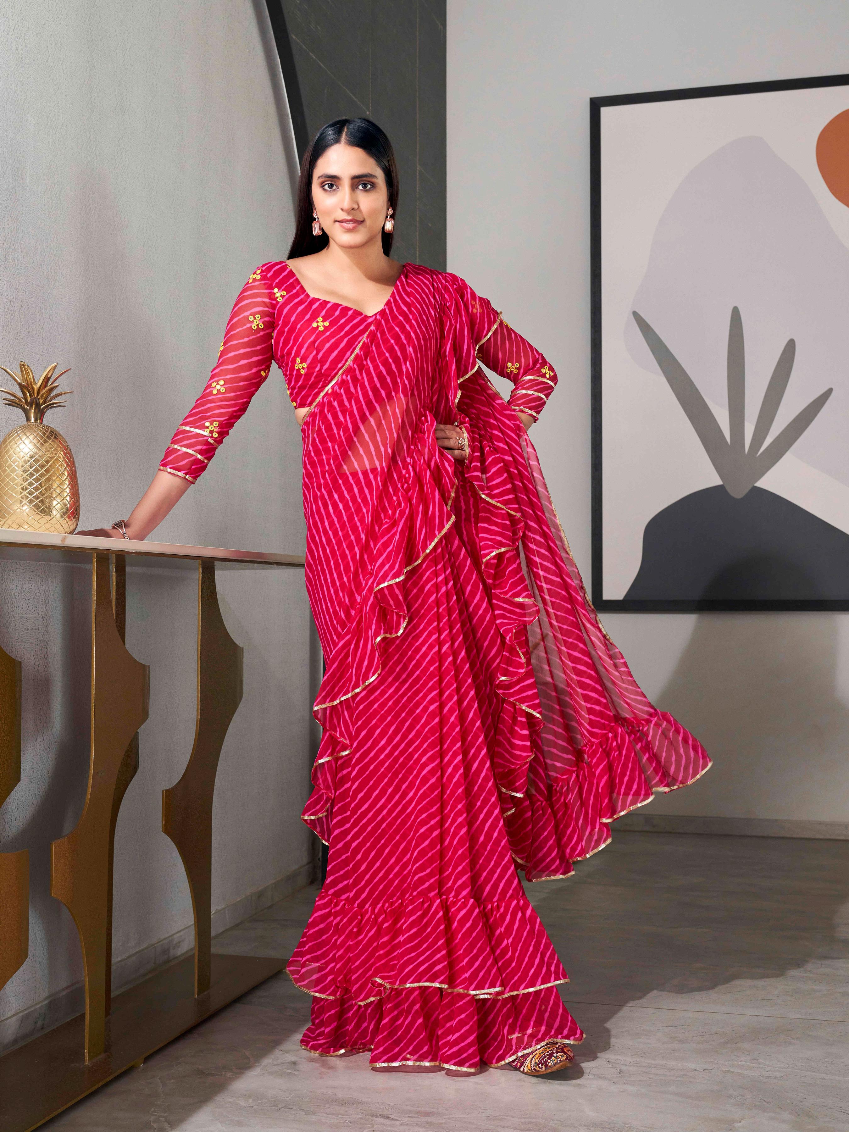 Pink colored lehariya saree with frill