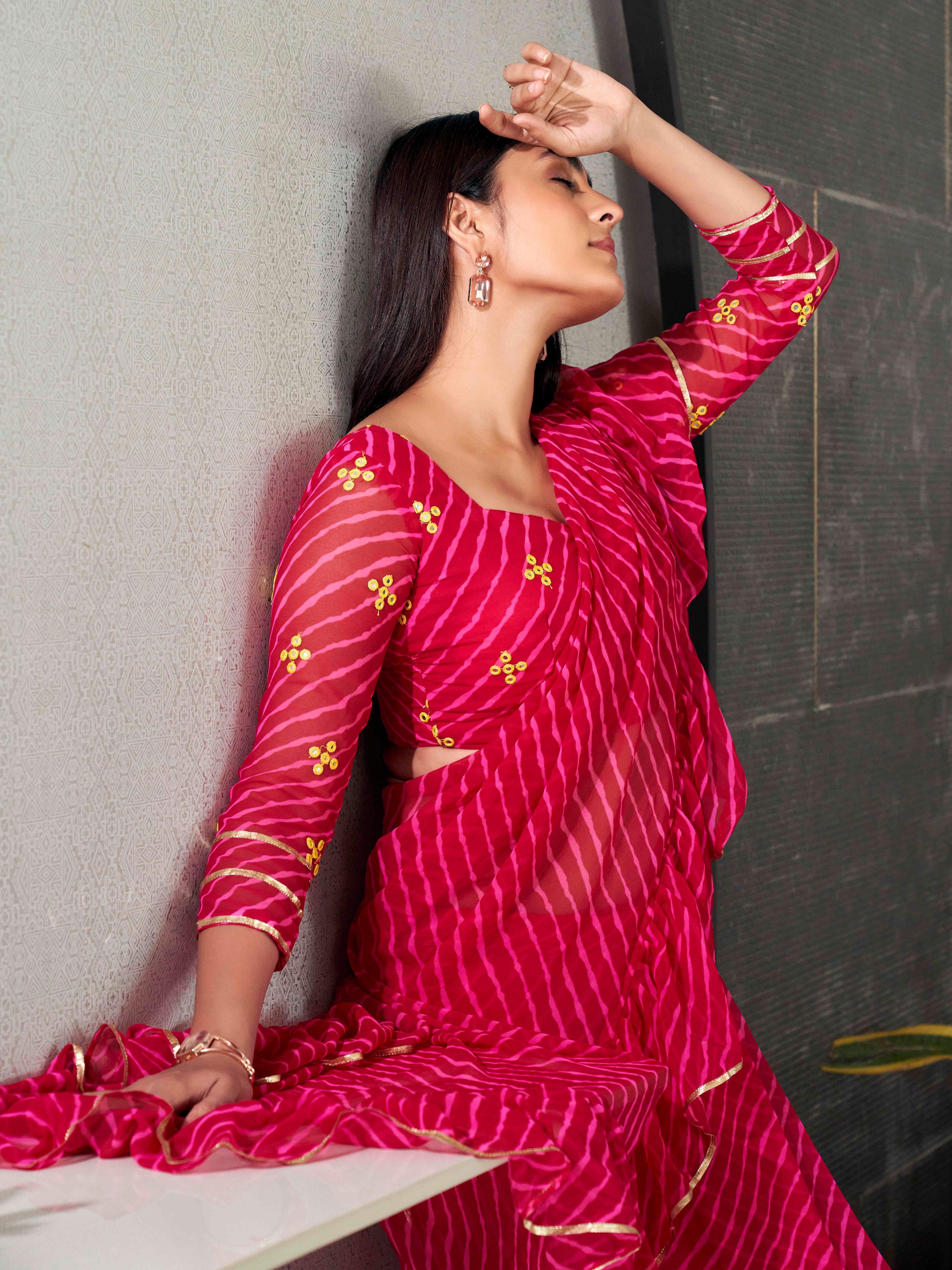 Pink colored lehariya saree with frill