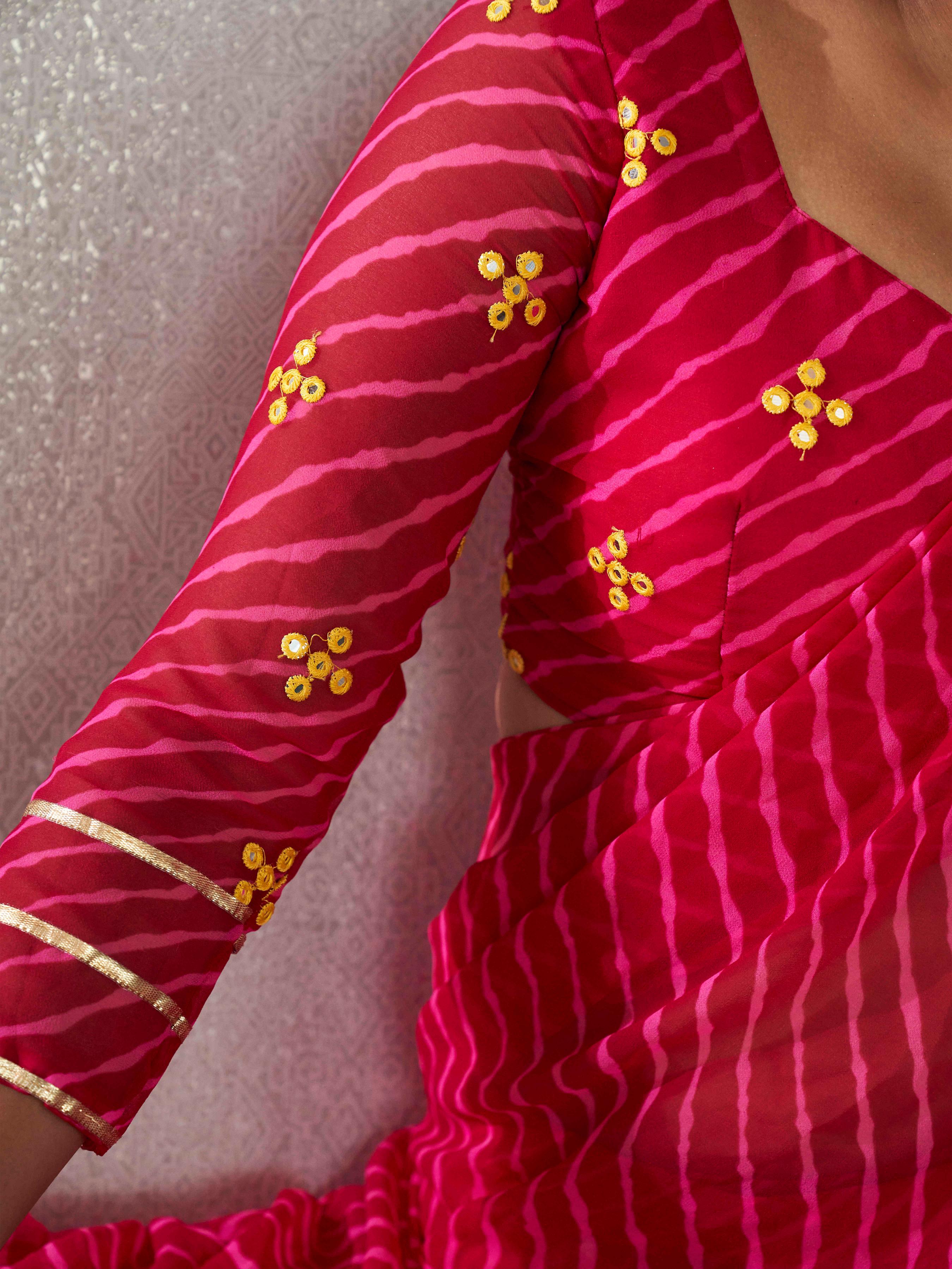 Pink colored lehariya saree with frill