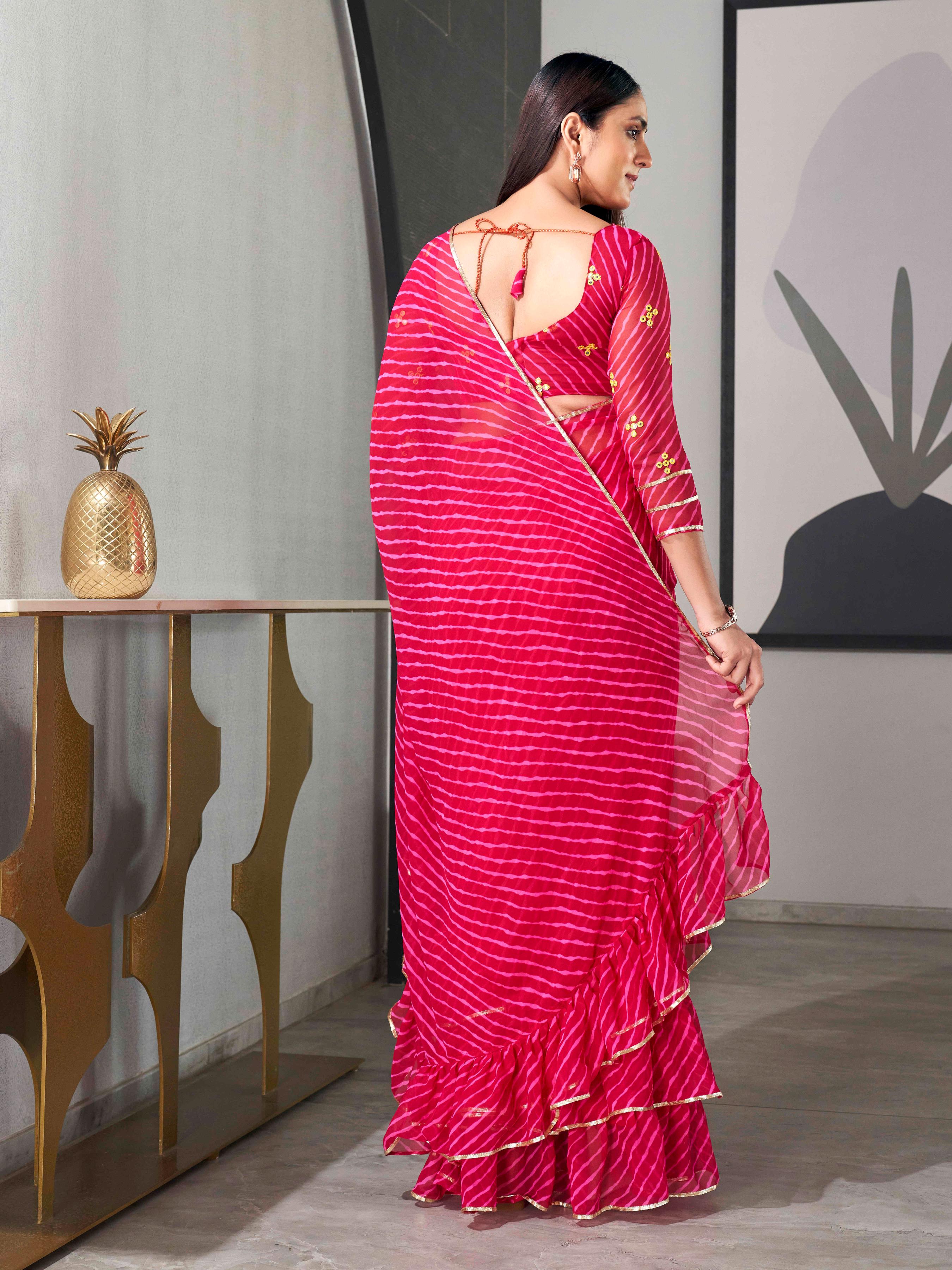 Pink colored lehariya saree with frill