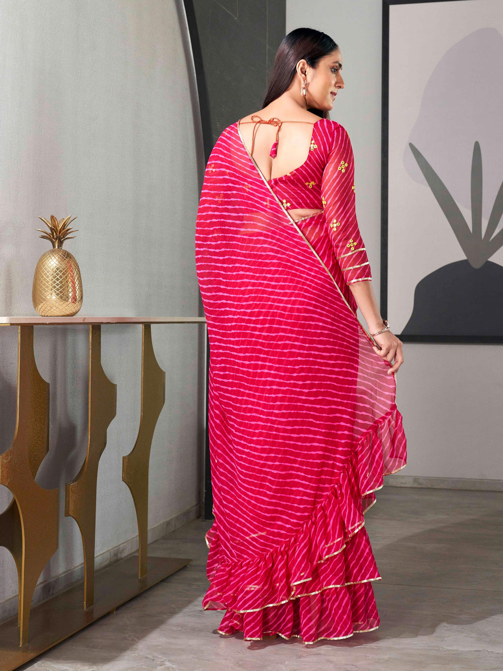 Pink colored lehariya saree with frill