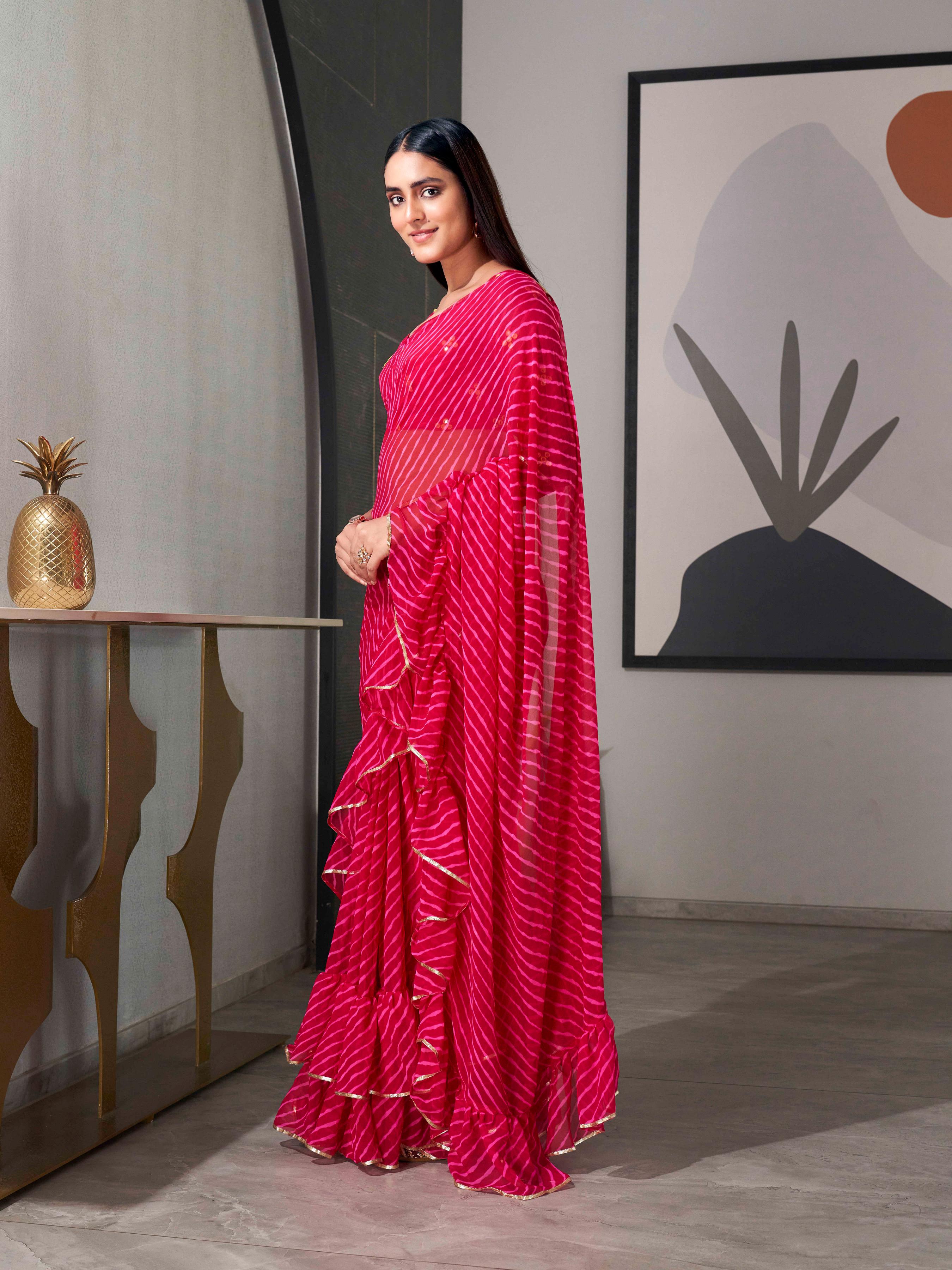 Pink colored lehariya saree with frill