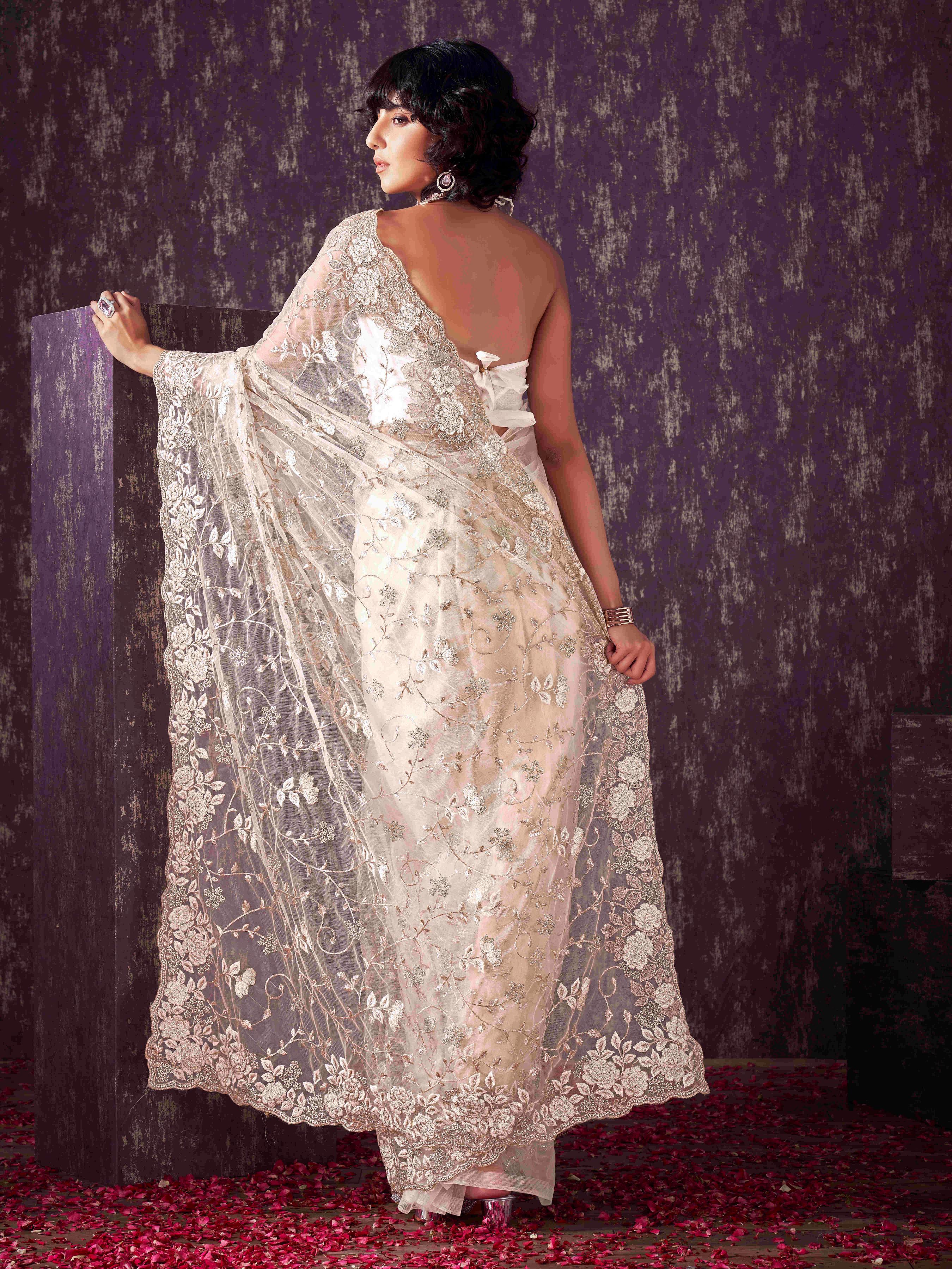 Off White colored embroidered net saree  with scalloped border