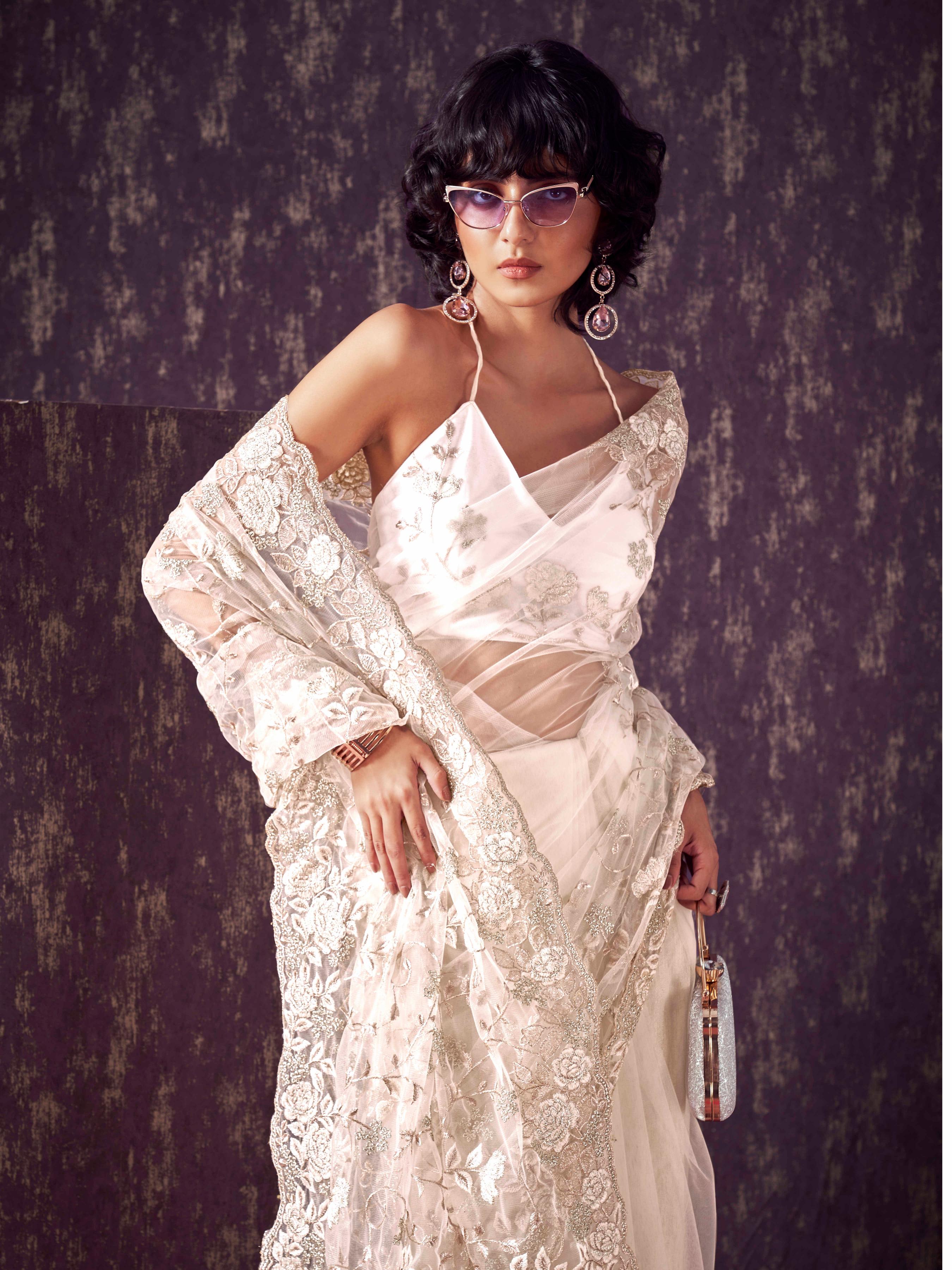 Off White colored embroidered net saree  with scalloped border