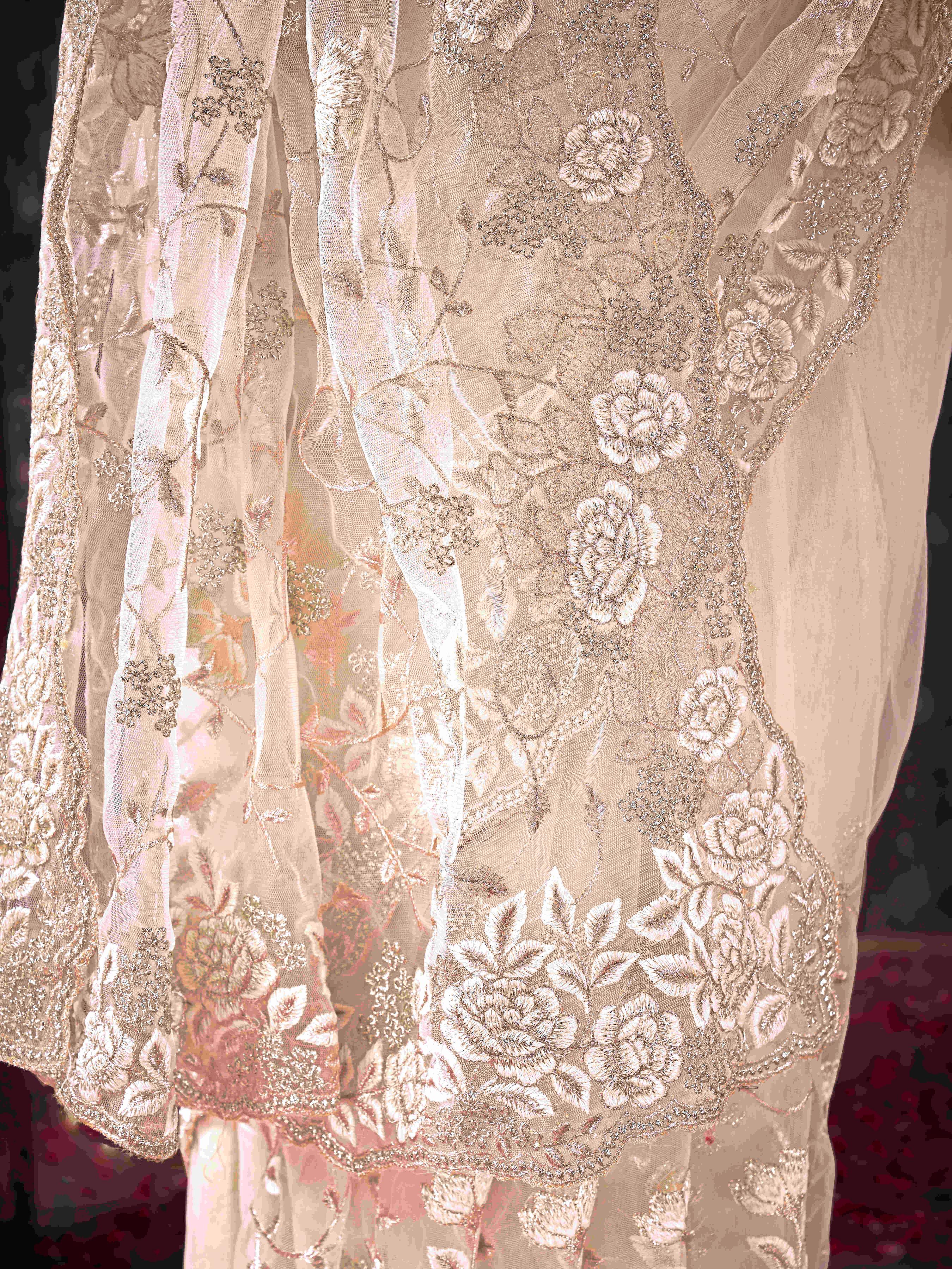 Off White colored embroidered net saree  with scalloped border
