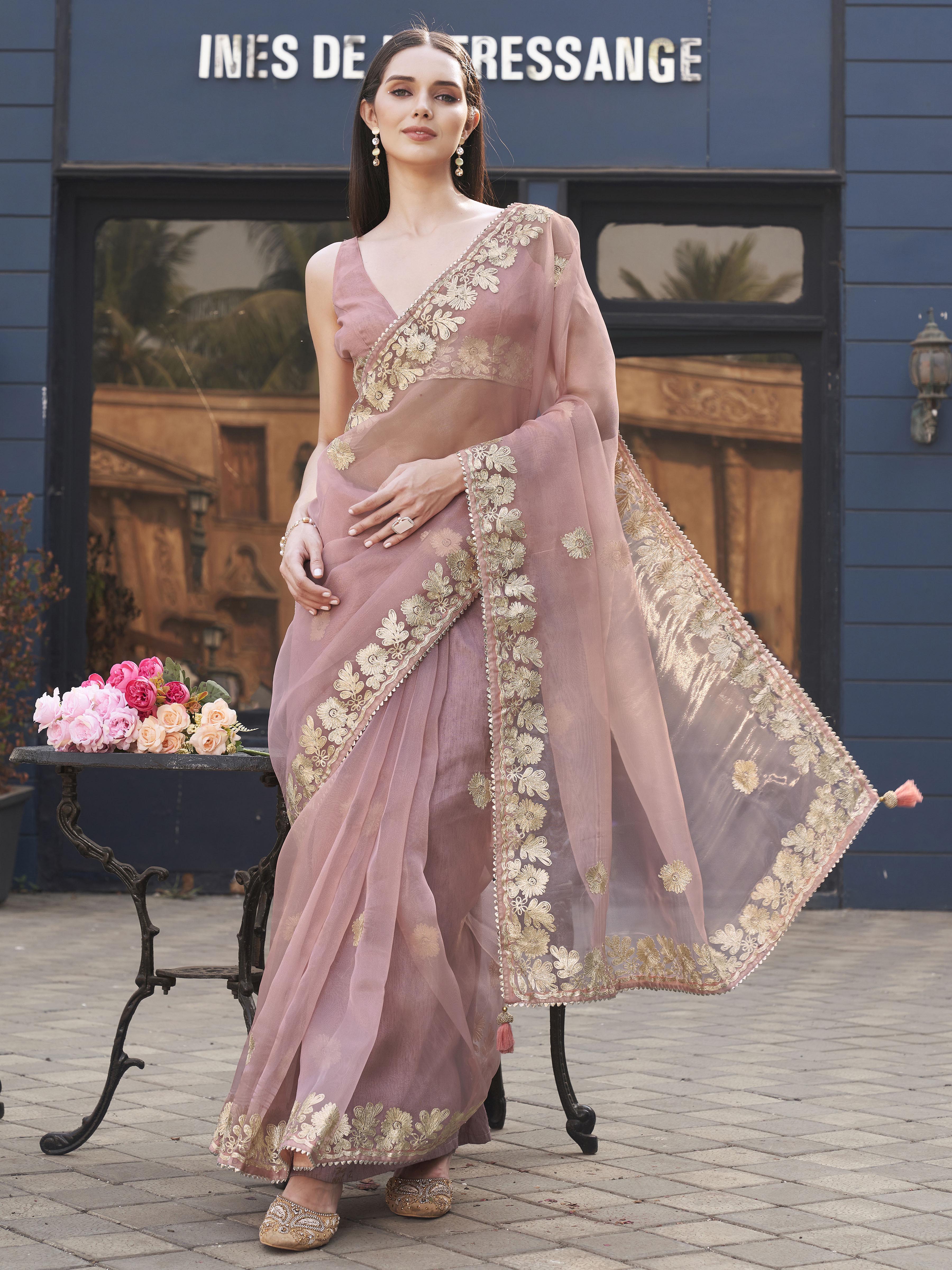 Pink colored organza saree with gota patti embroidery and embellished border