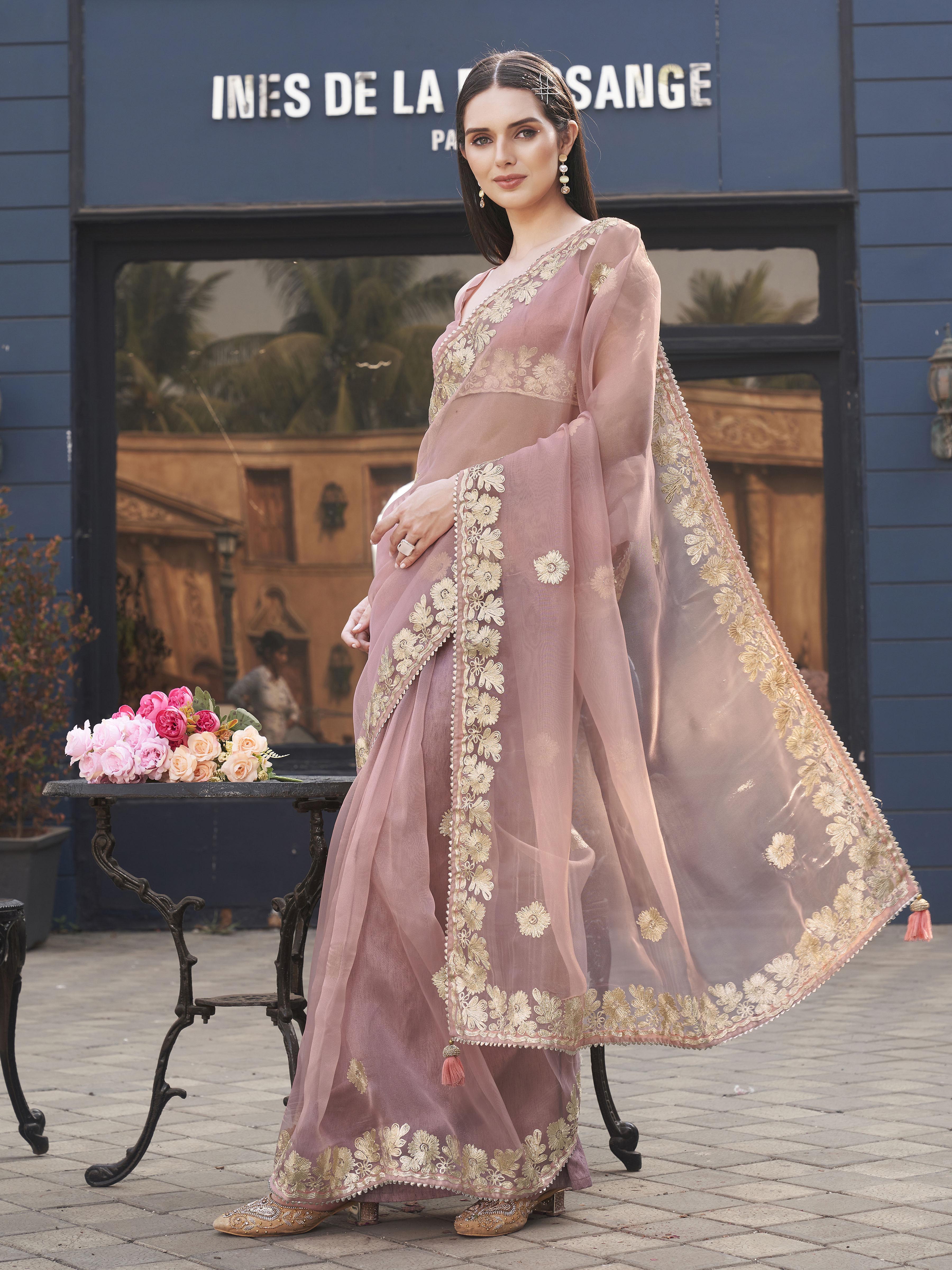 Pink colored organza saree with gota patti embroidery and embellished border