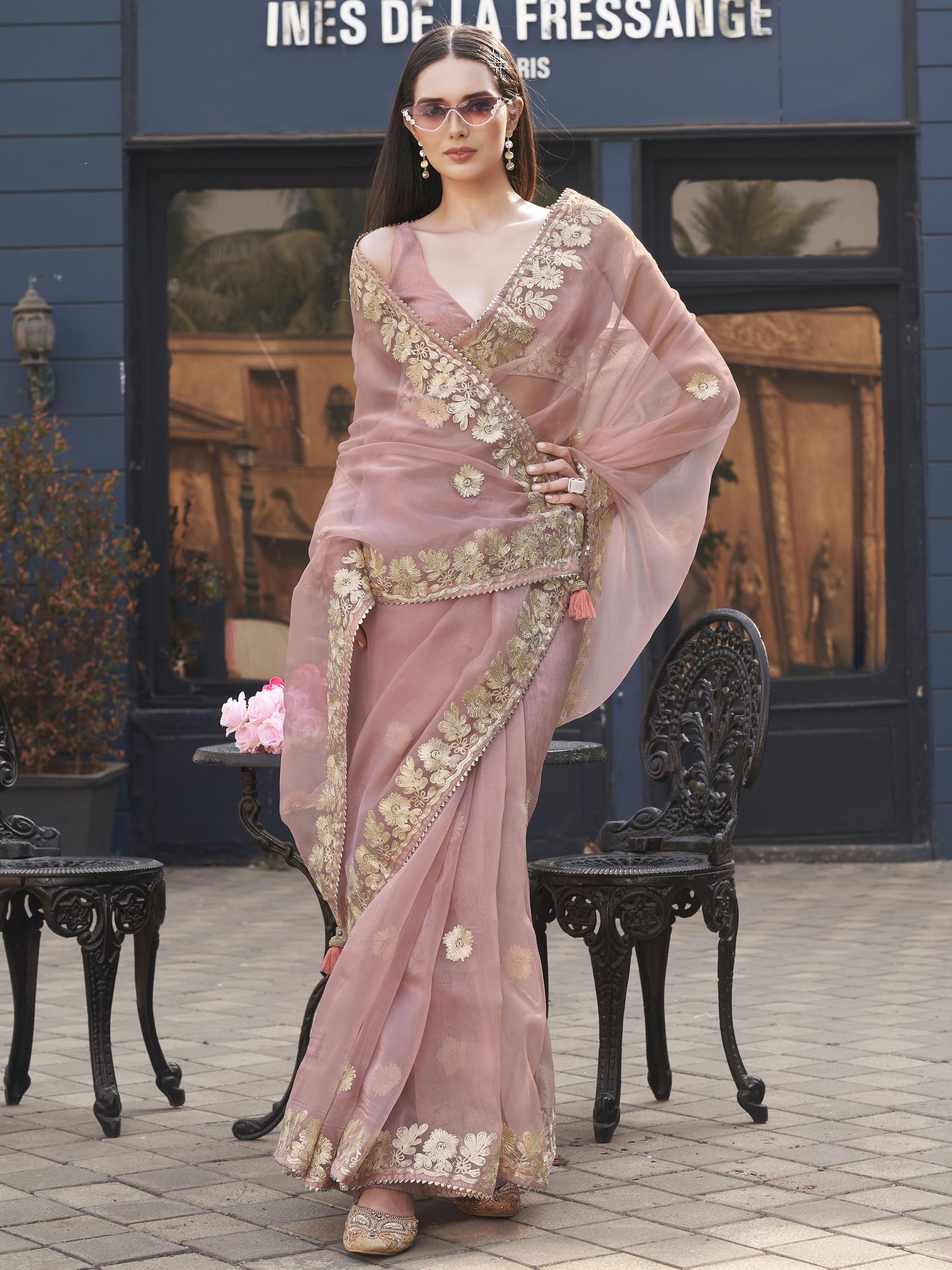 Pink colored organza saree with gota patti embroidery and embellished border