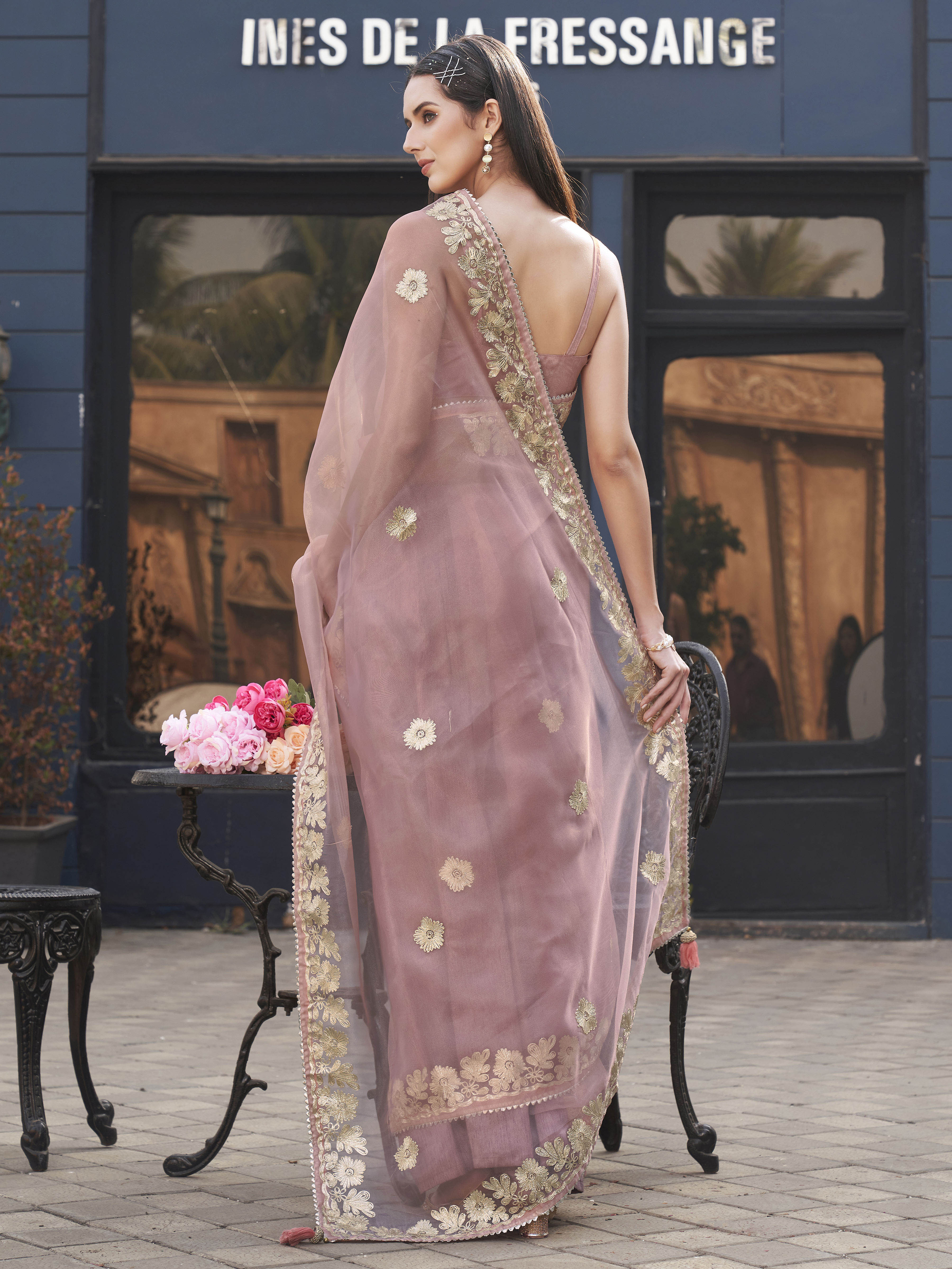 Pink colored organza saree with gota patti embroidery and embellished border