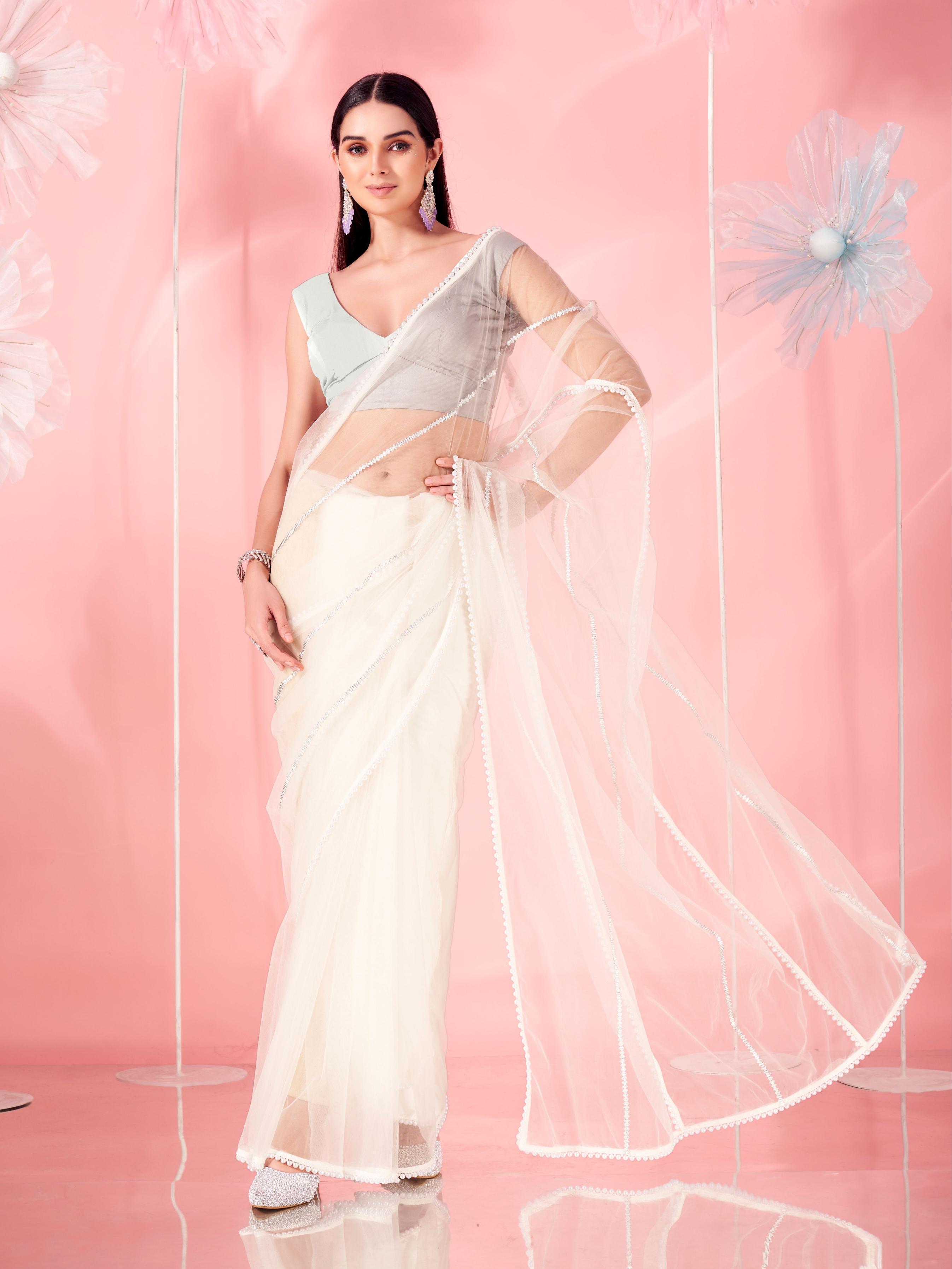 Off white colored designer net saree with faux beads and pearls stitched on pallu