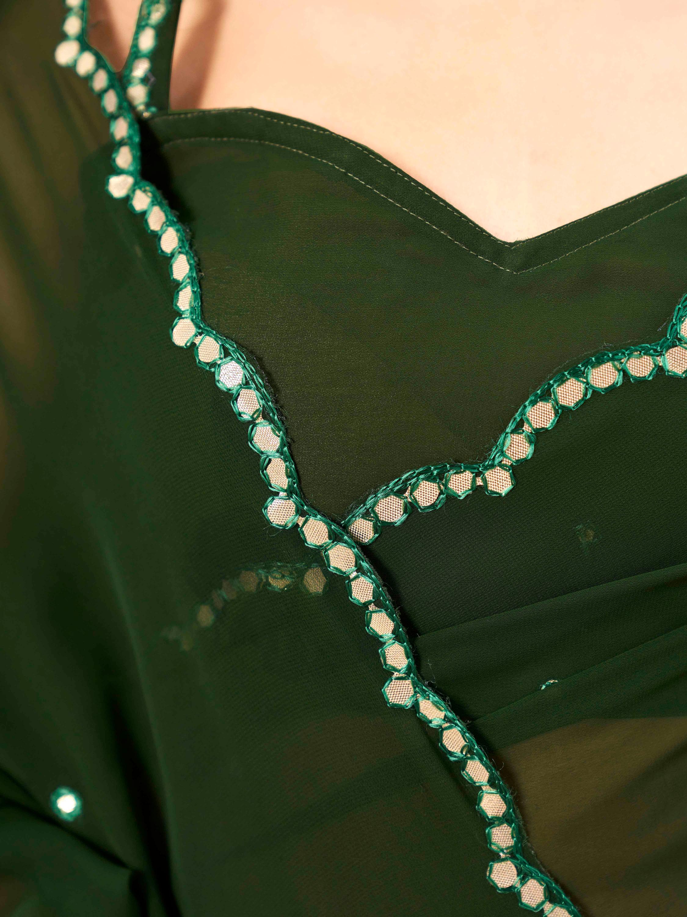 Green colored organza saree with embellished work