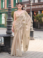 Beige colored burbery satin saree with sequinned embroidered butta on pallu and scalloped border