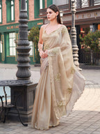 Beige colored burbery satin saree with sequinned embroidered butta on pallu and scalloped border