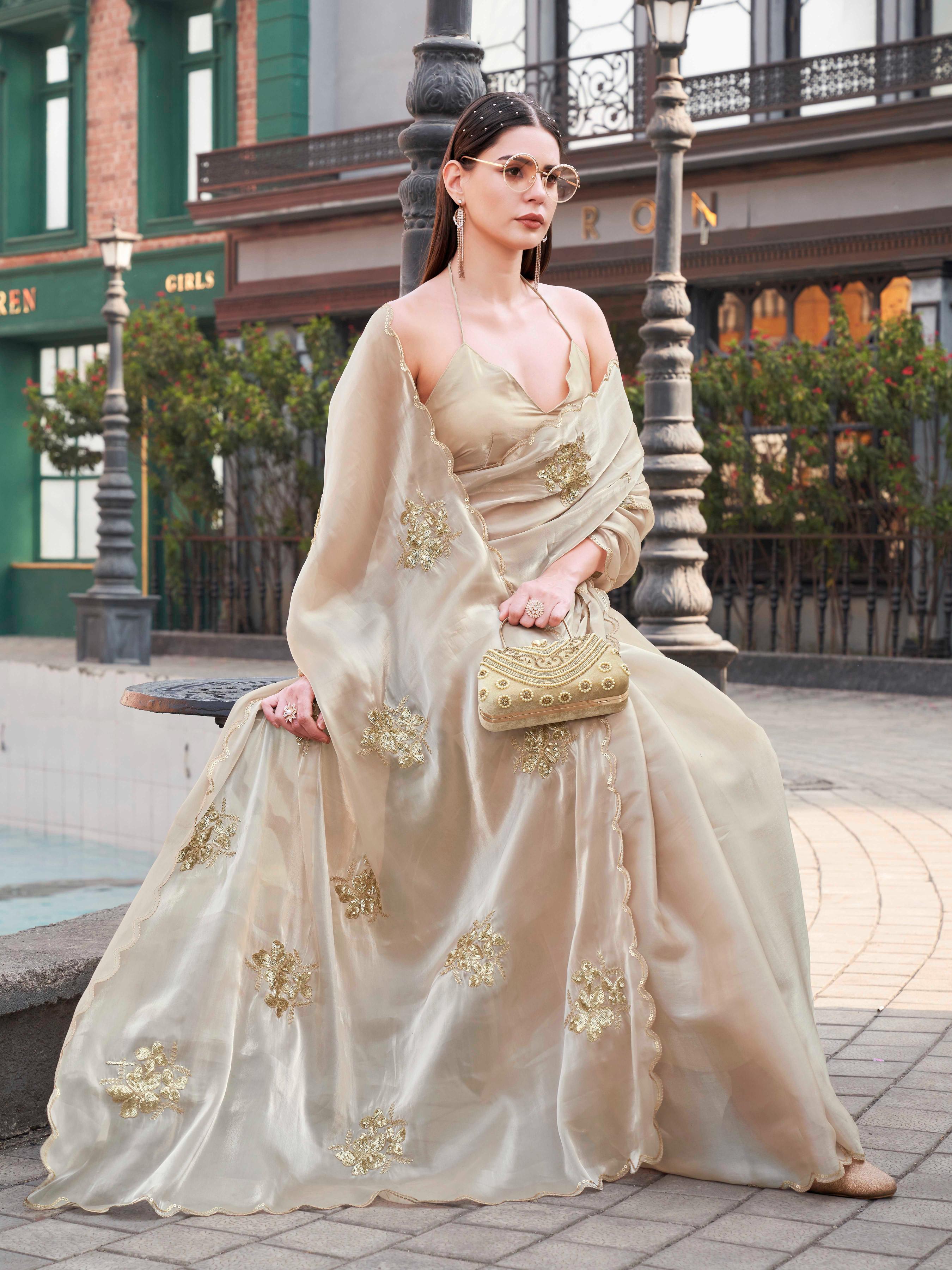 Beige colored burbery satin saree with sequinned embroidered butta on pallu and scalloped border