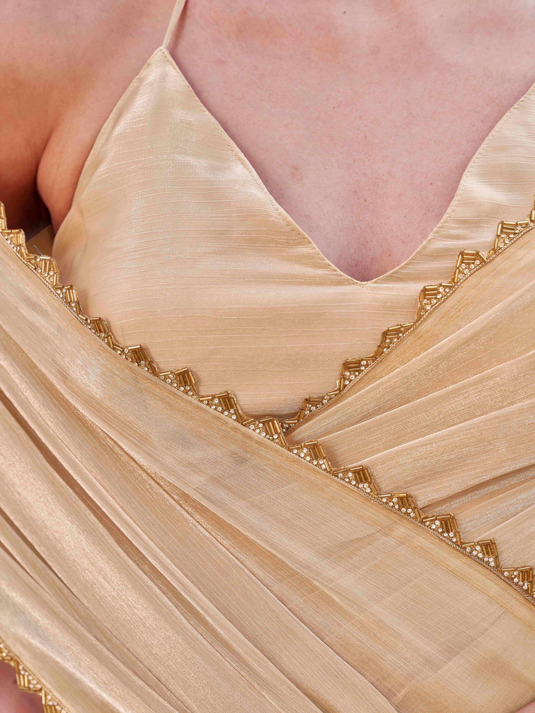 Beige colored jimy cho saree with handwork border