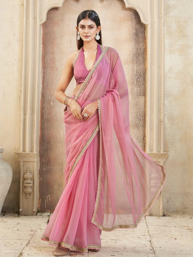 Pink colored chiffon saree with embellished lace and brocade blouse