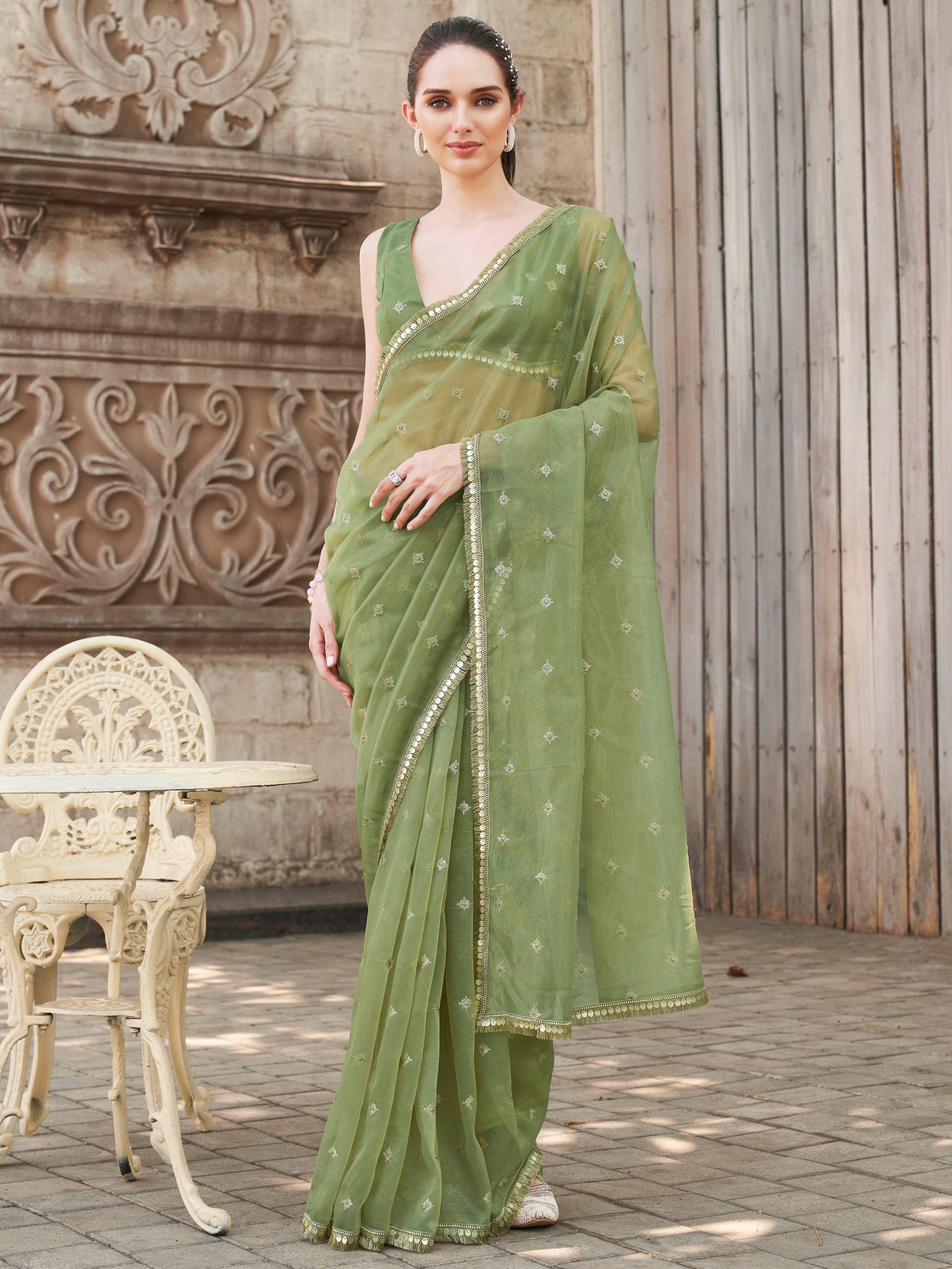 Green colored shimmer net saree with sequinned butti and embroidered border
