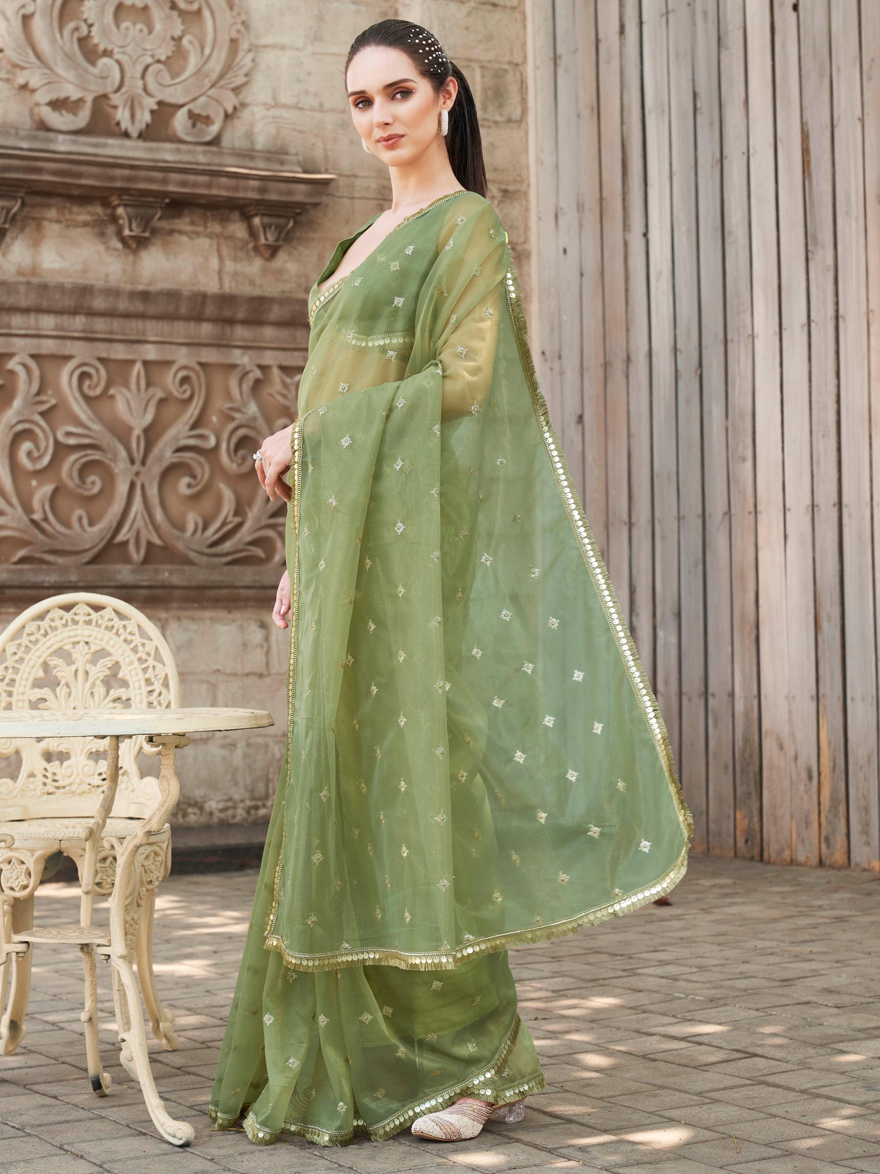Green colored shimmer net saree with sequinned butti and embroidered border