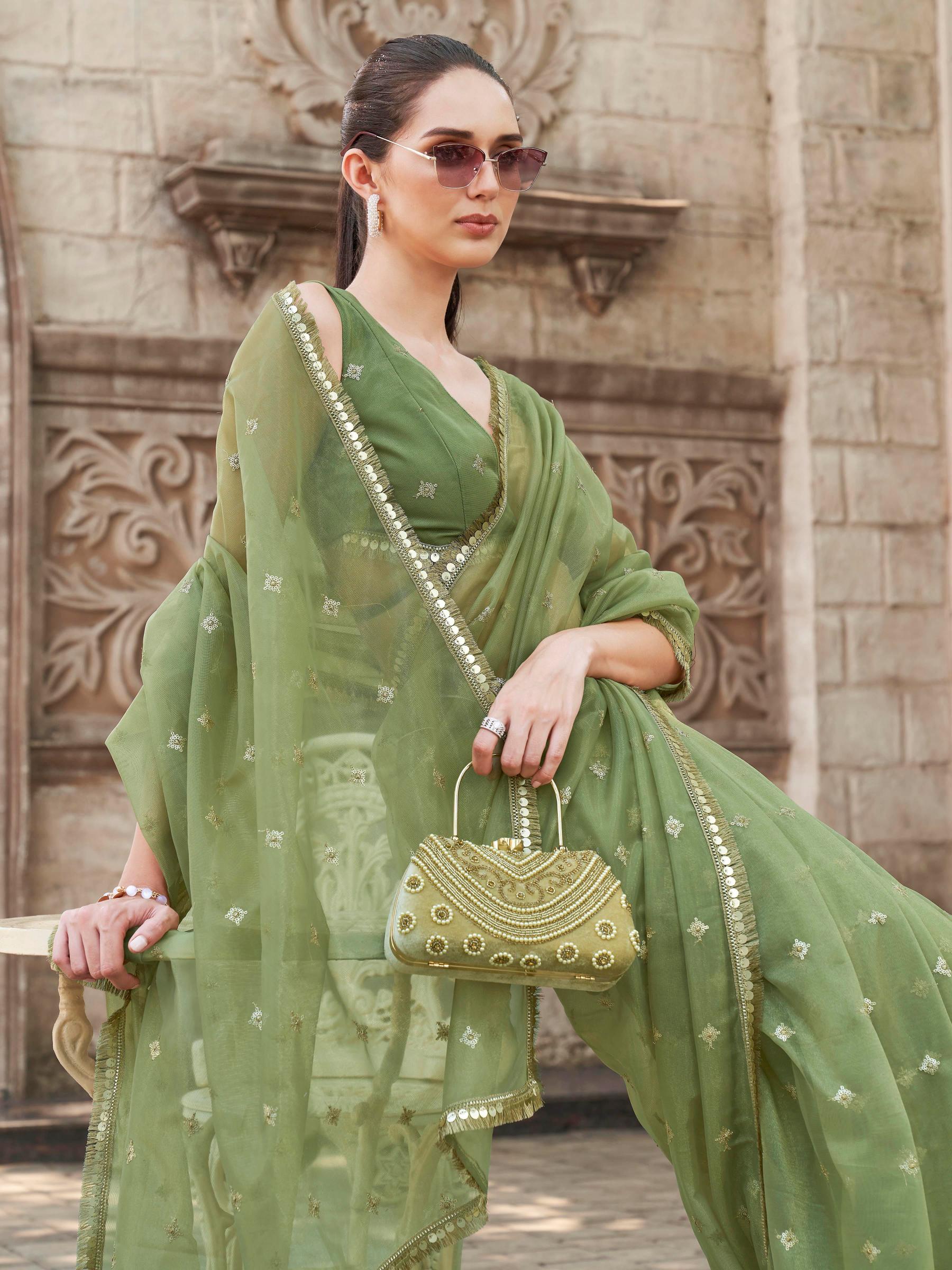 Green colored shimmer net saree with sequinned butti and embroidered border