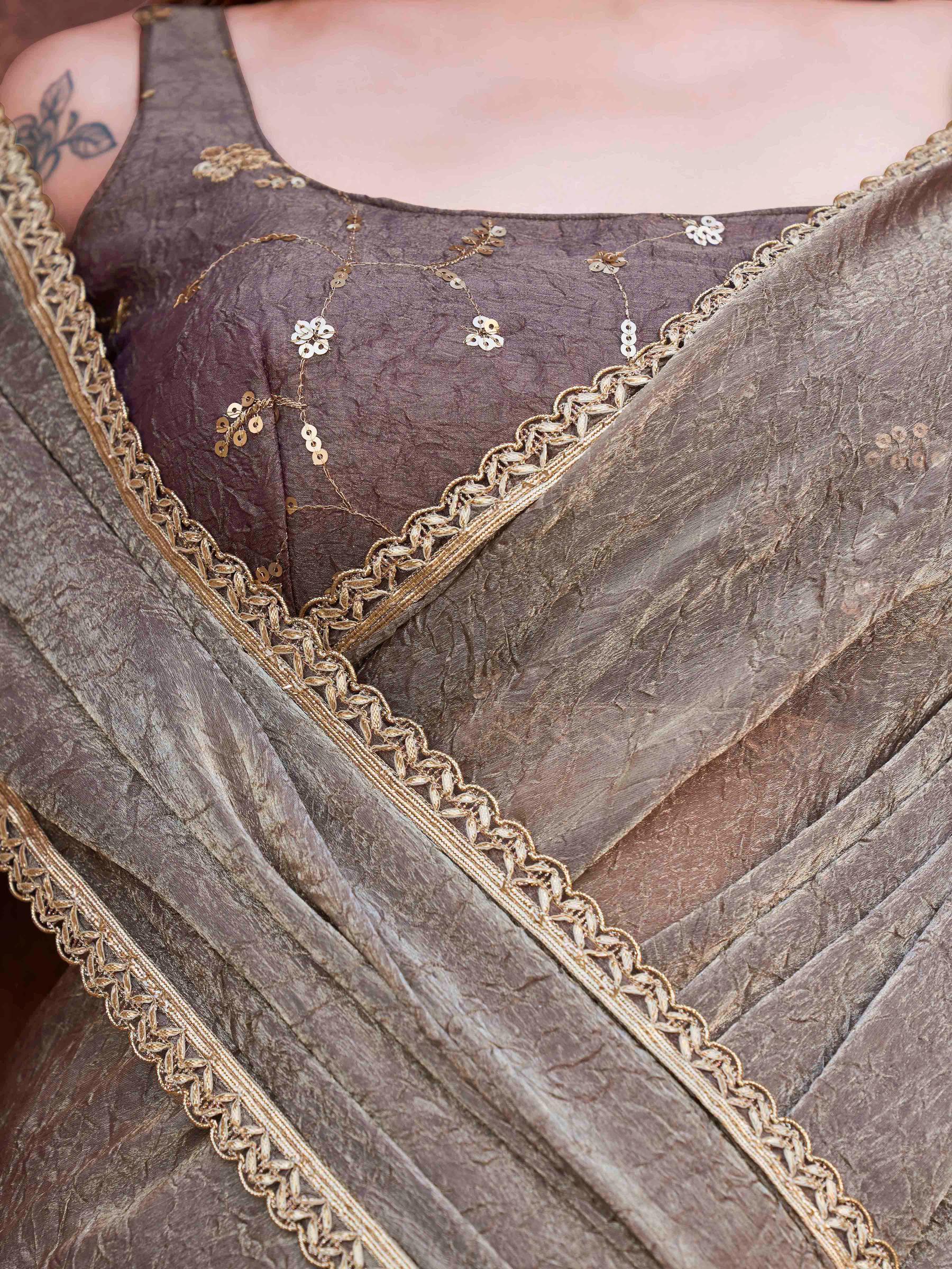 Two toned grey and pink colored wrinkled saree with embroidered blouse and embellished lace
