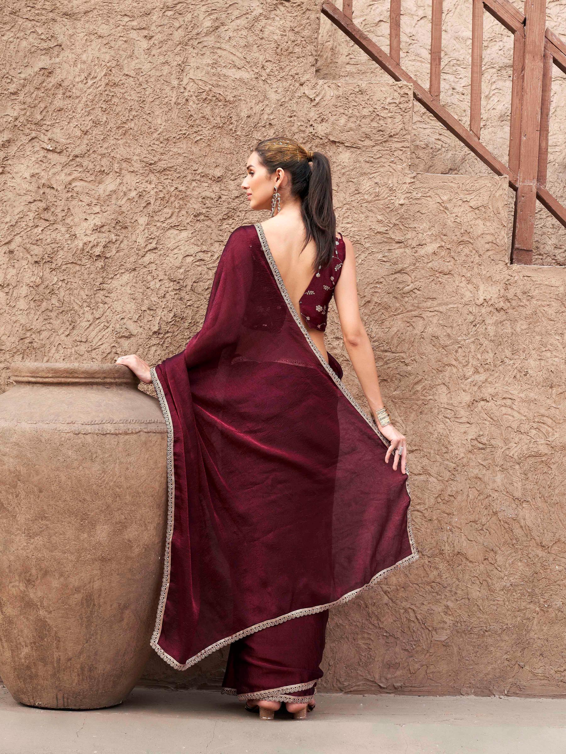 Two toned maroon colored wrinkled saree with embroidered blouse and embellished lace