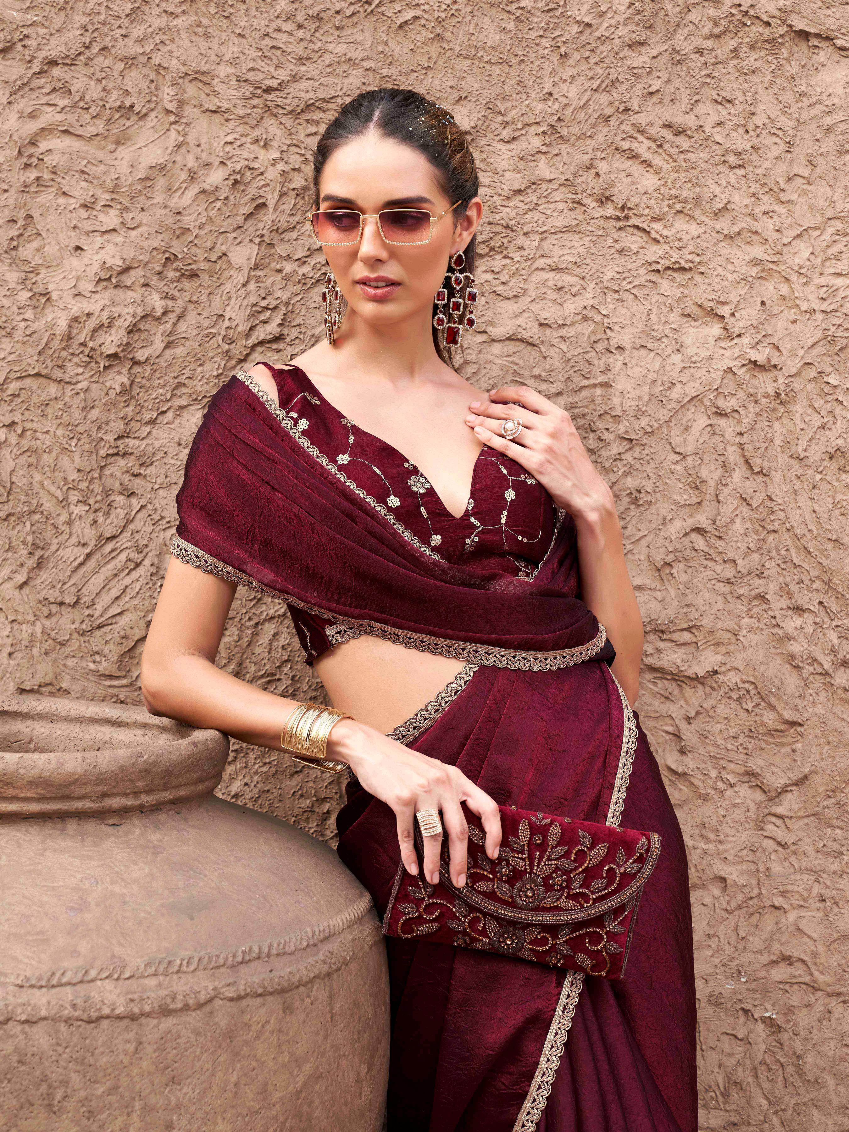 Two toned maroon colored wrinkled saree with embroidered blouse and embellished lace