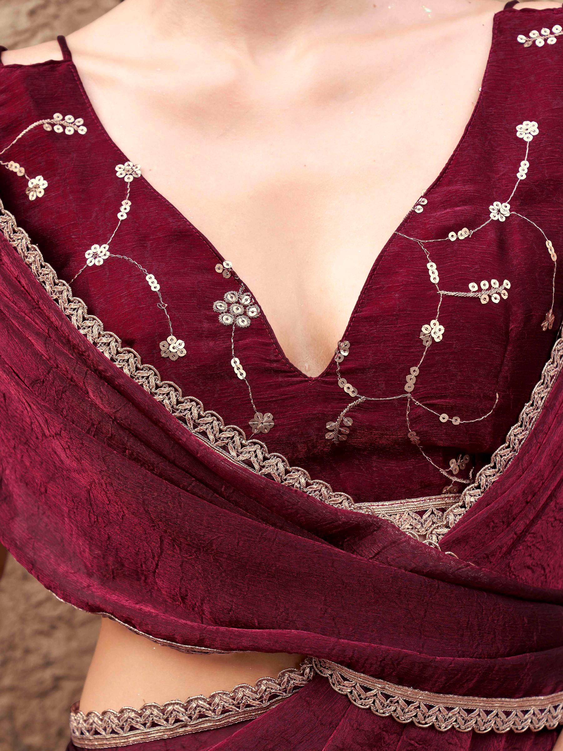 Two toned maroon colored wrinkled saree with embroidered blouse and embellished lace