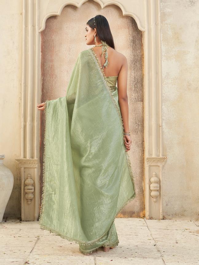 Pista green colored crunchy saree with sequinned lace and brocade blouse