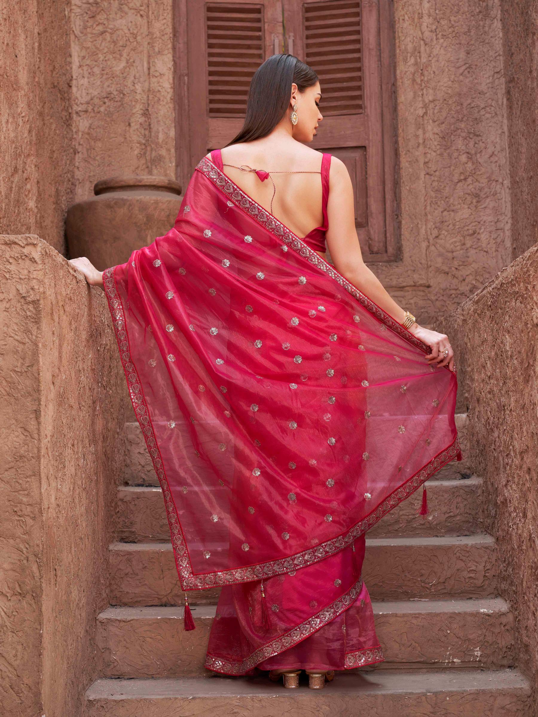 Pink colored net saree with sequence embroidered lace