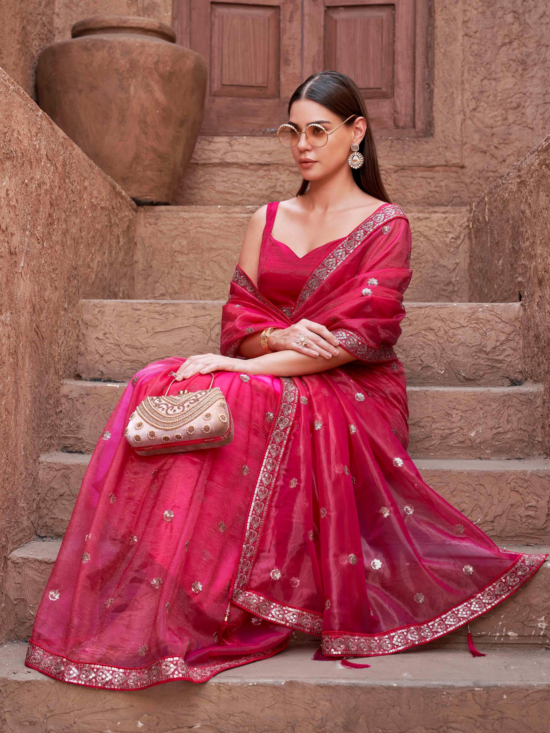 Pink colored net saree with sequence embroidered lace