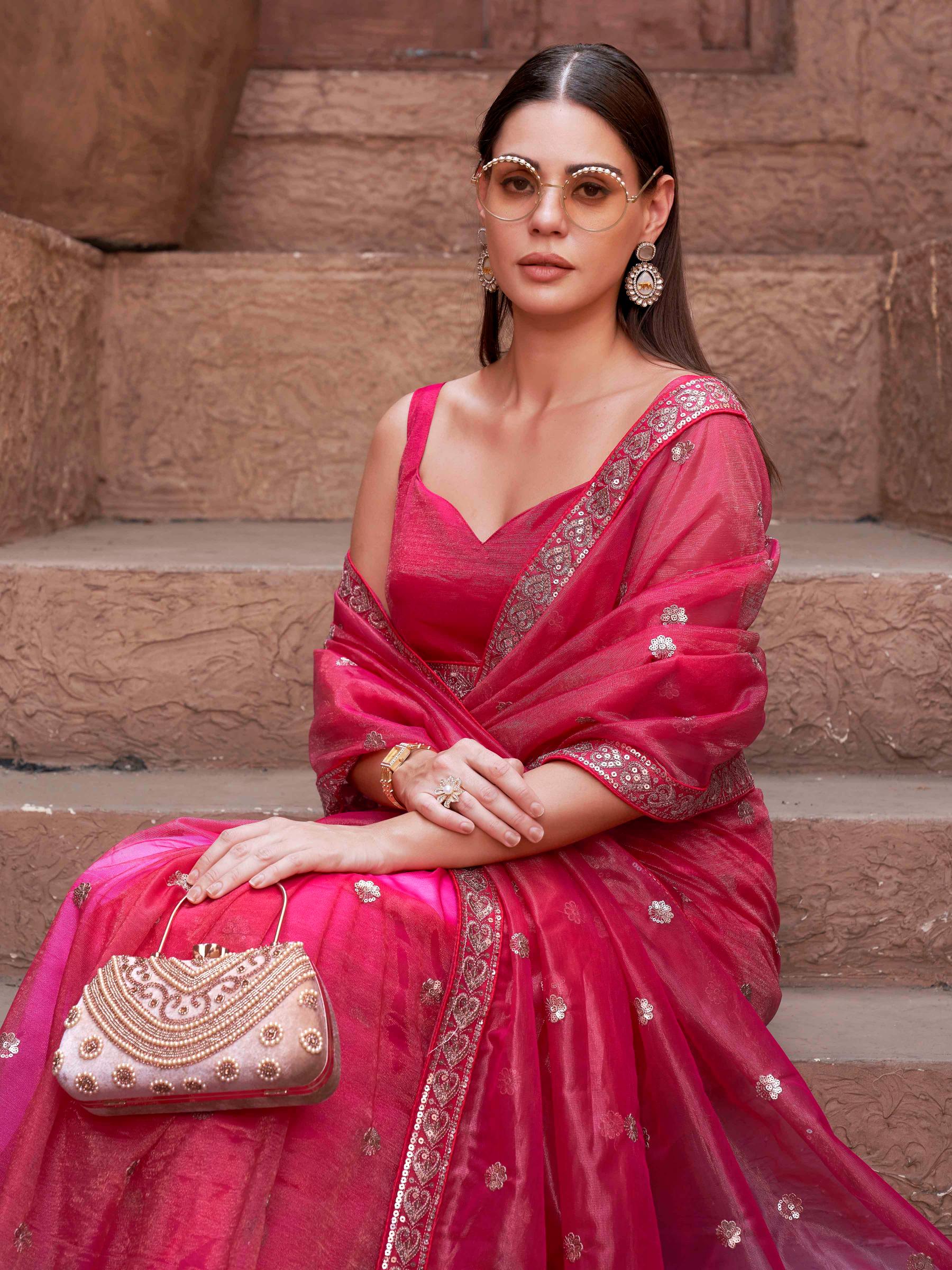 Pink colored net saree with sequence embroidered lace