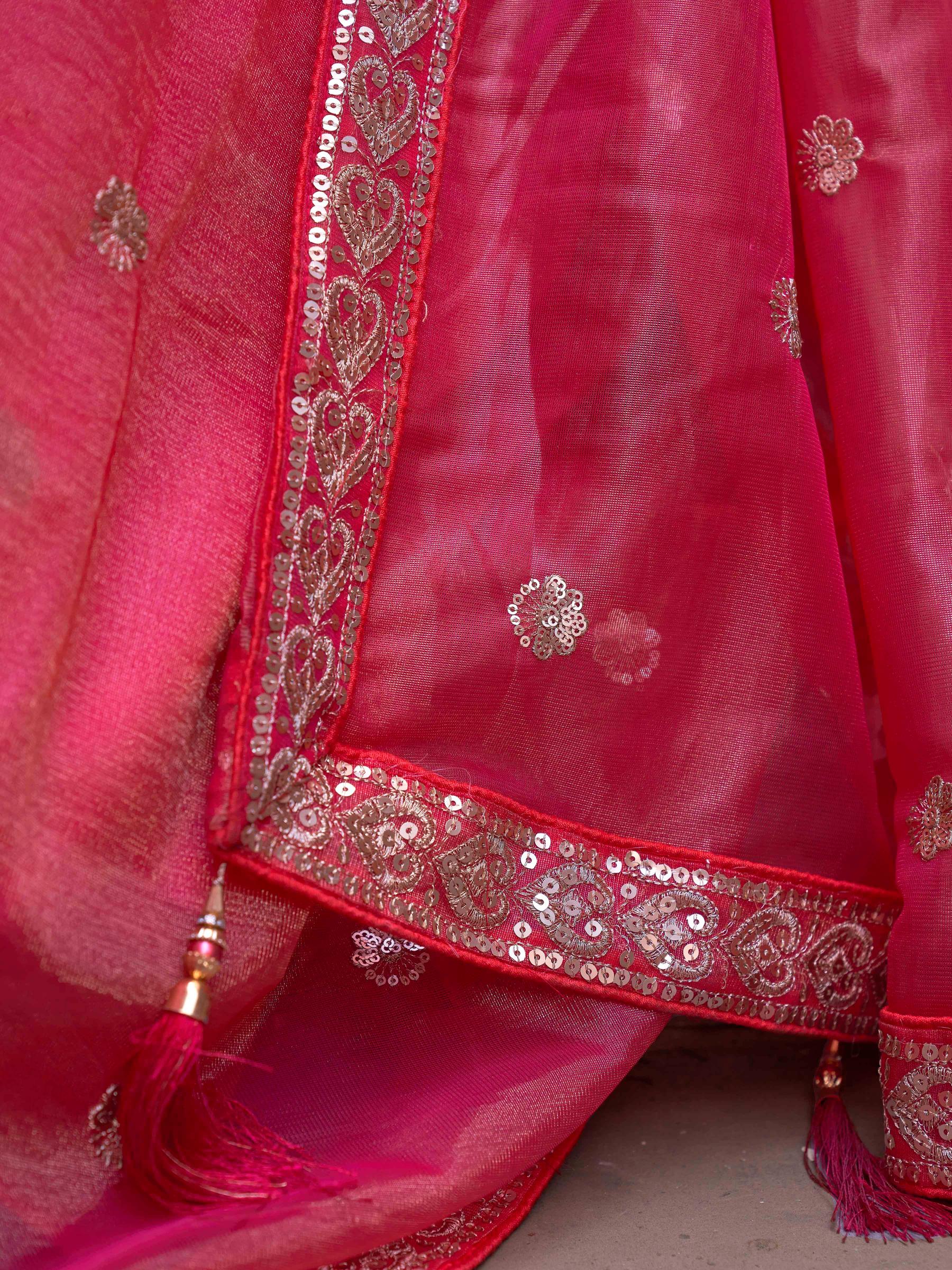 Pink colored net saree with sequence embroidered lace