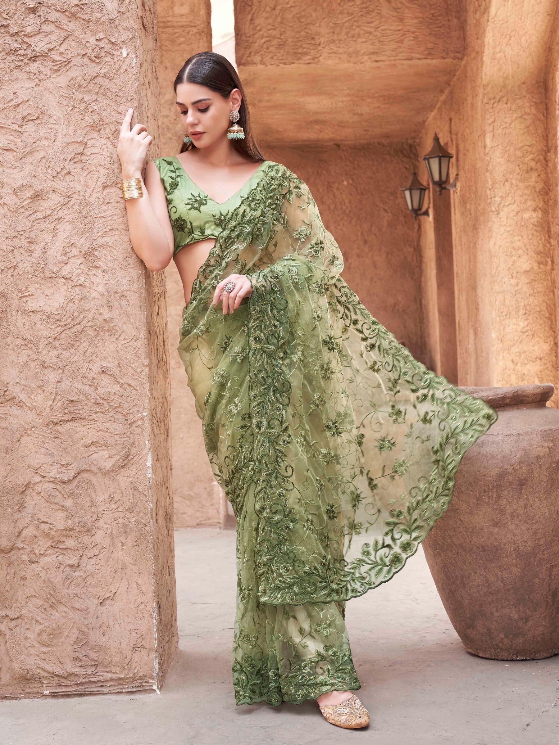 olive green colored embroidered net saree with scalloped border