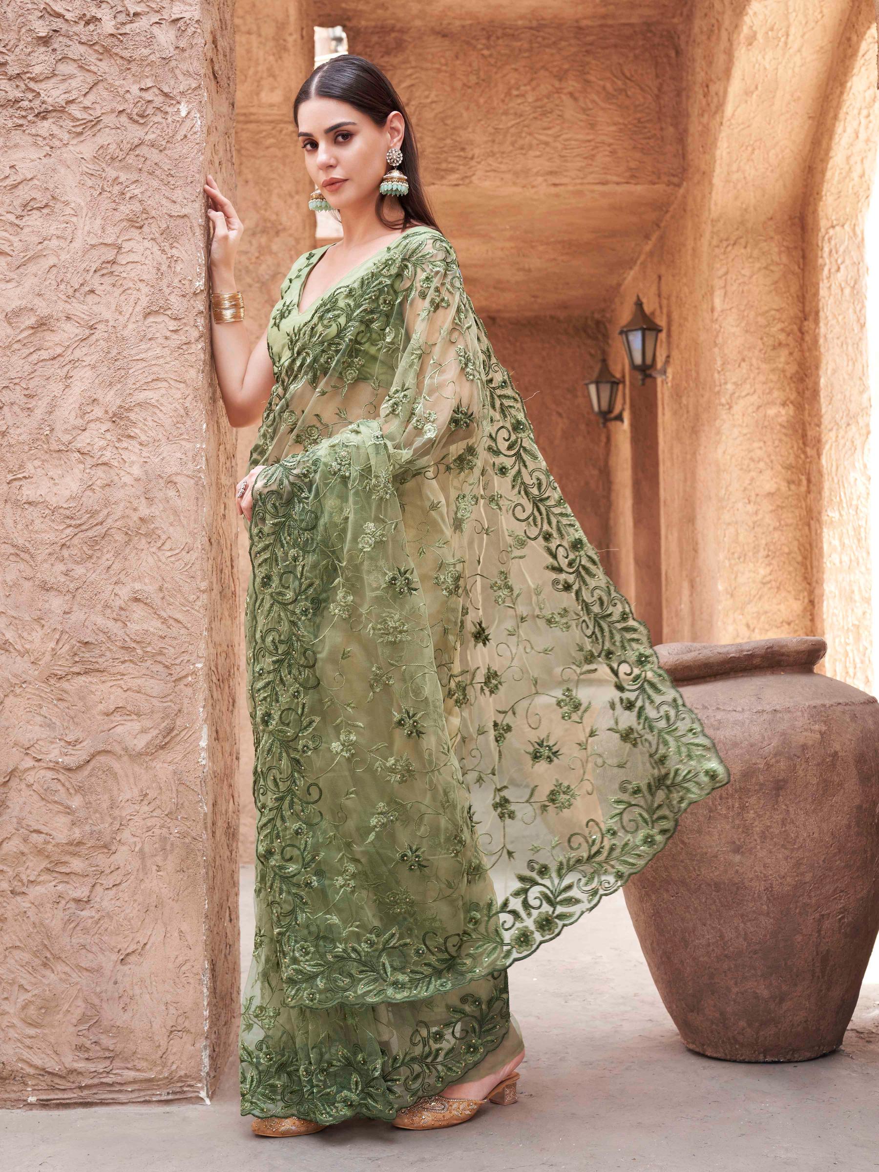 olive green colored embroidered net saree with scalloped border