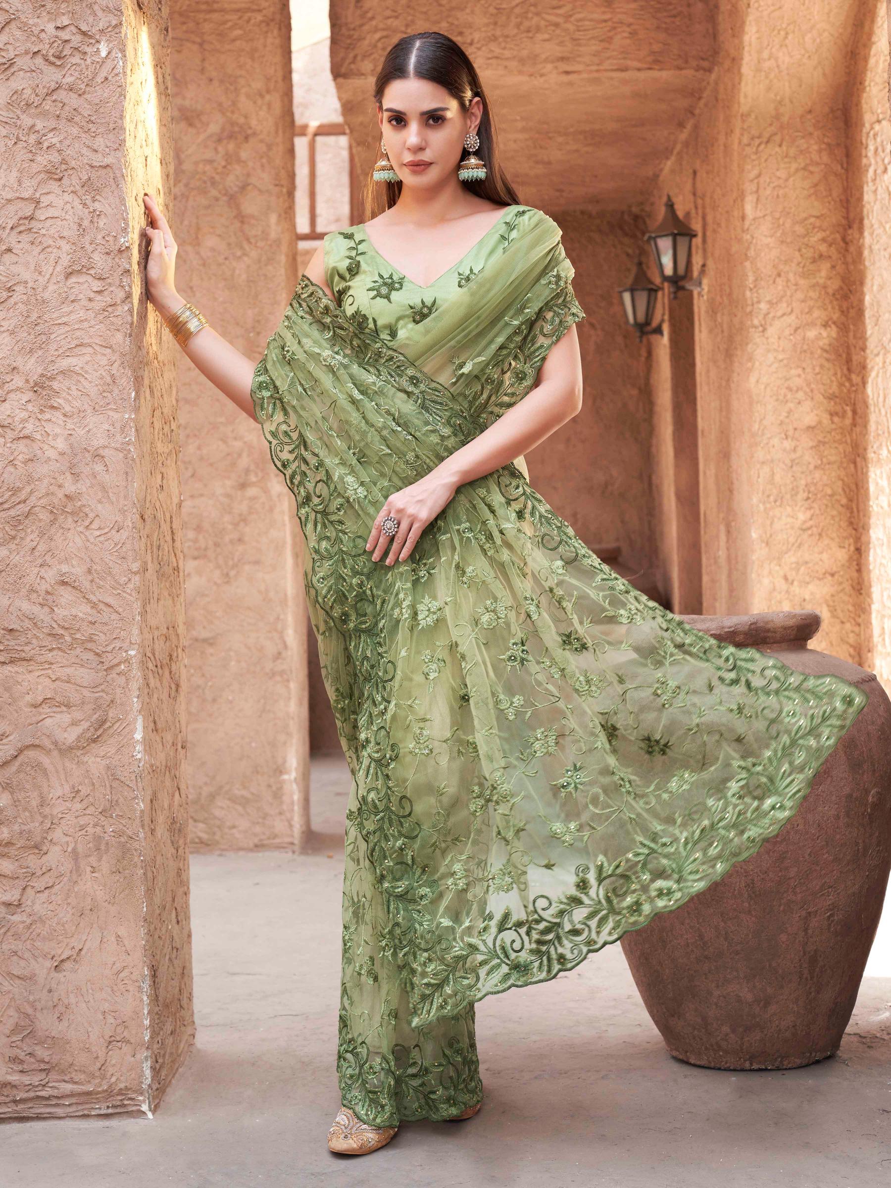 olive green colored embroidered net saree with scalloped border