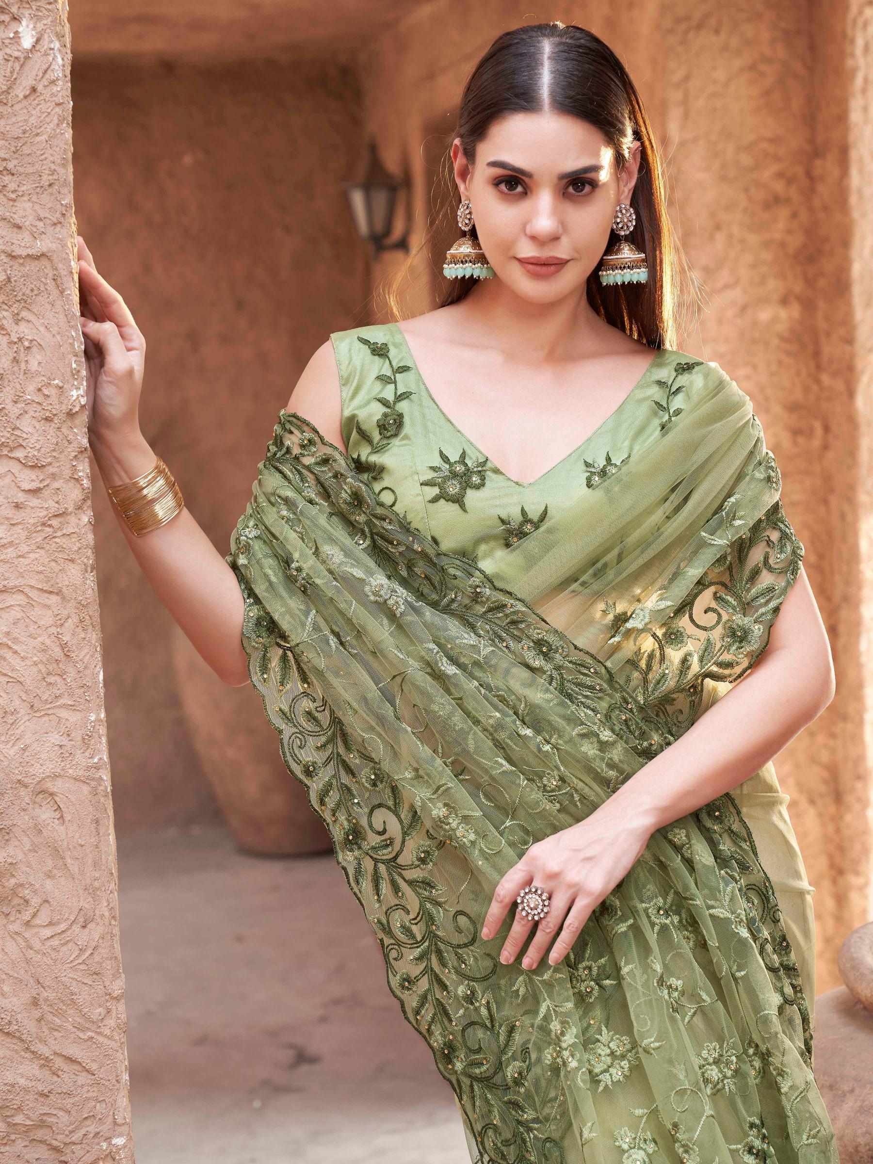 olive green colored embroidered net saree with scalloped border