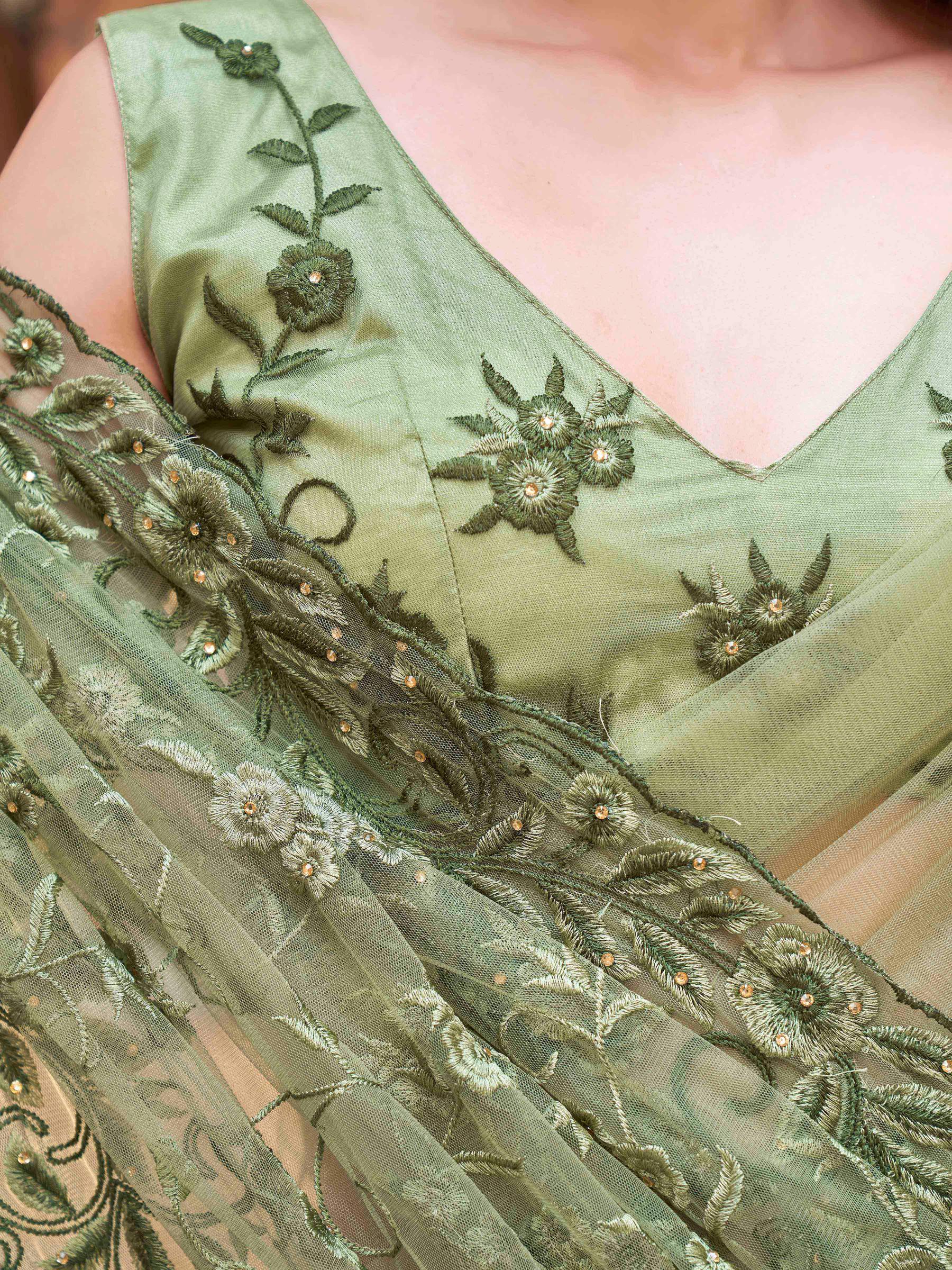 olive green colored embroidered net saree with scalloped border