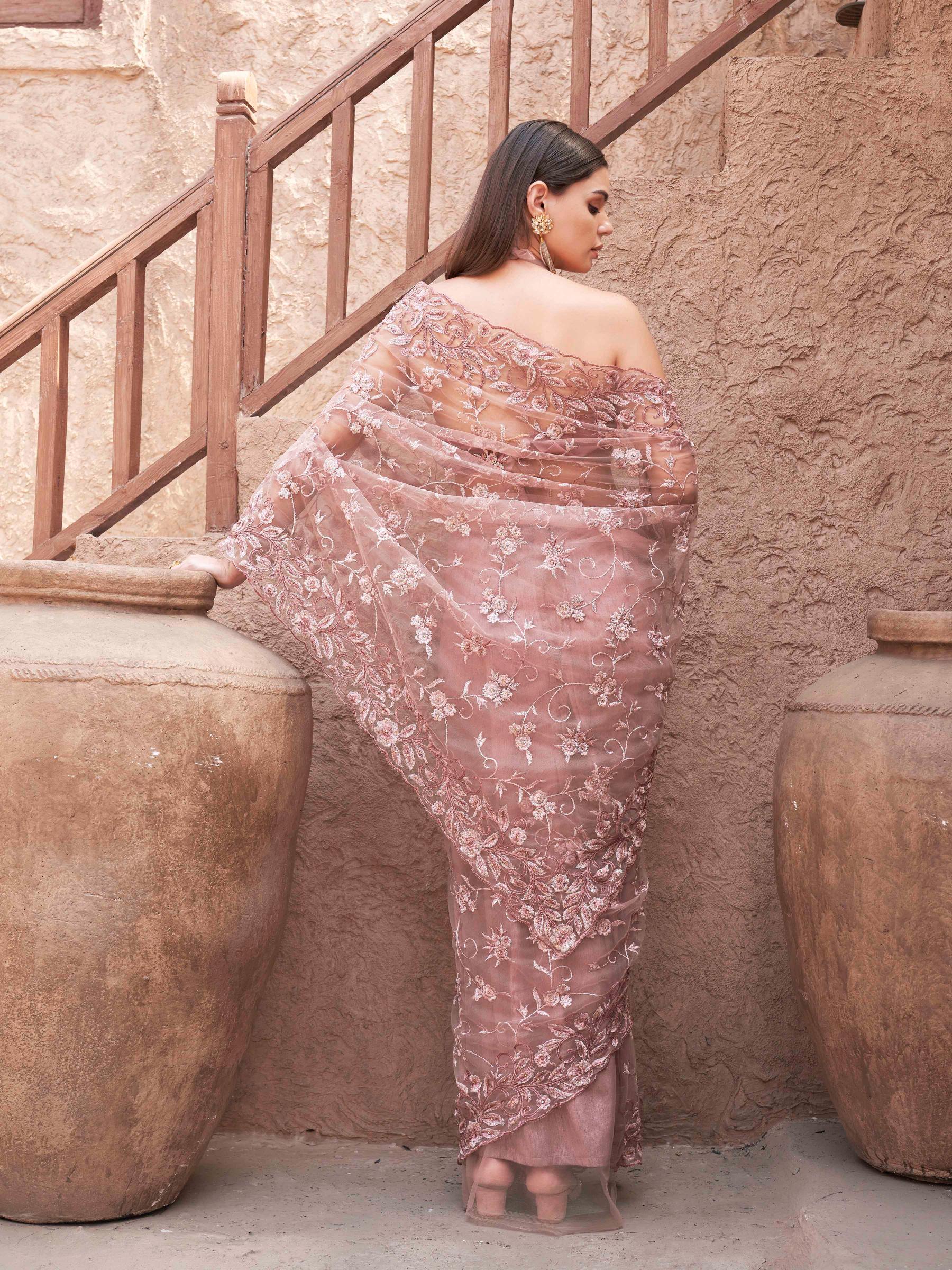mauve colored embroidered net saree with scalloped border