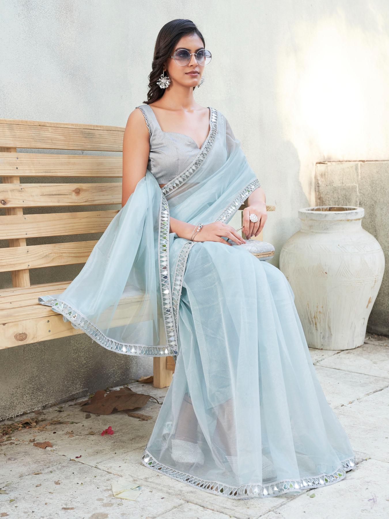 Blue colored designer shimmer net saree with mirror work border