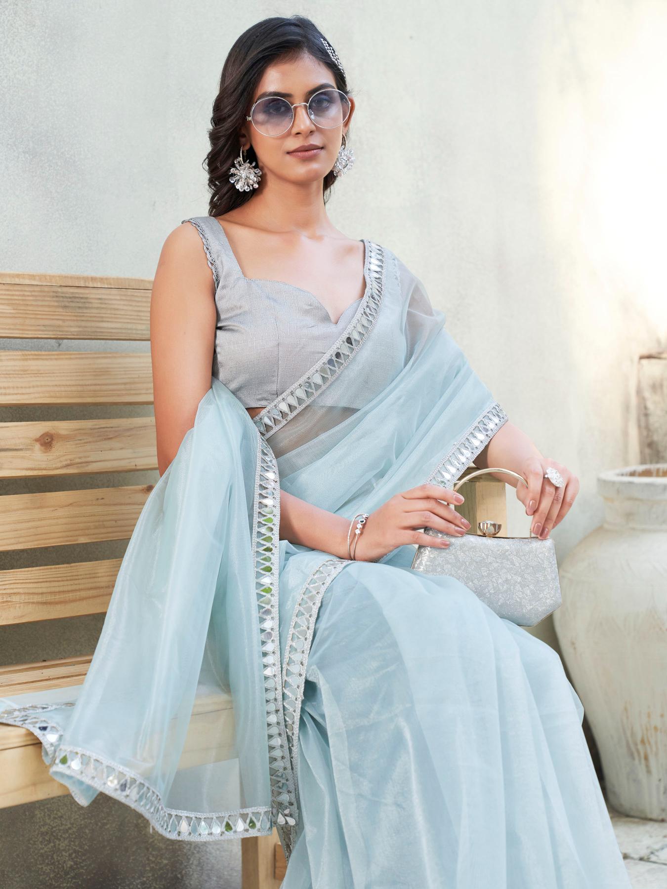 Blue colored designer shimmer net saree with mirror work border