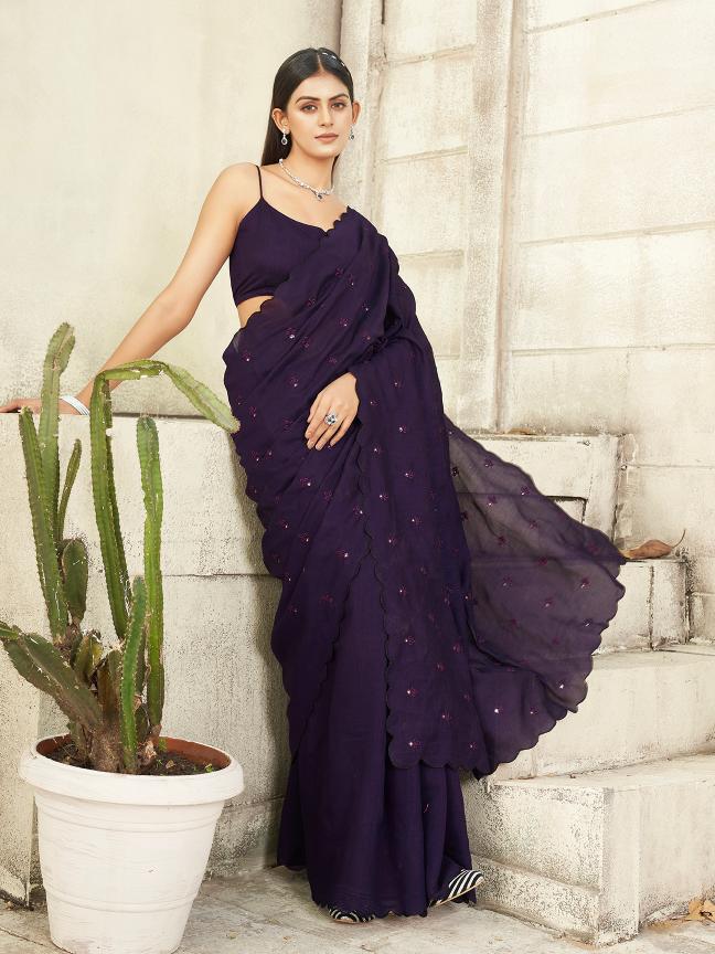 purple colored saree with mirror embroidery on pallu and scalloped border