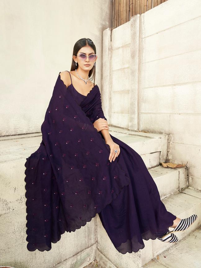 purple colored saree with mirror embroidery on pallu and scalloped border