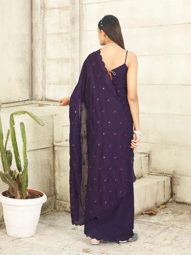 purple colored saree with mirror embroidery on pallu and scalloped border