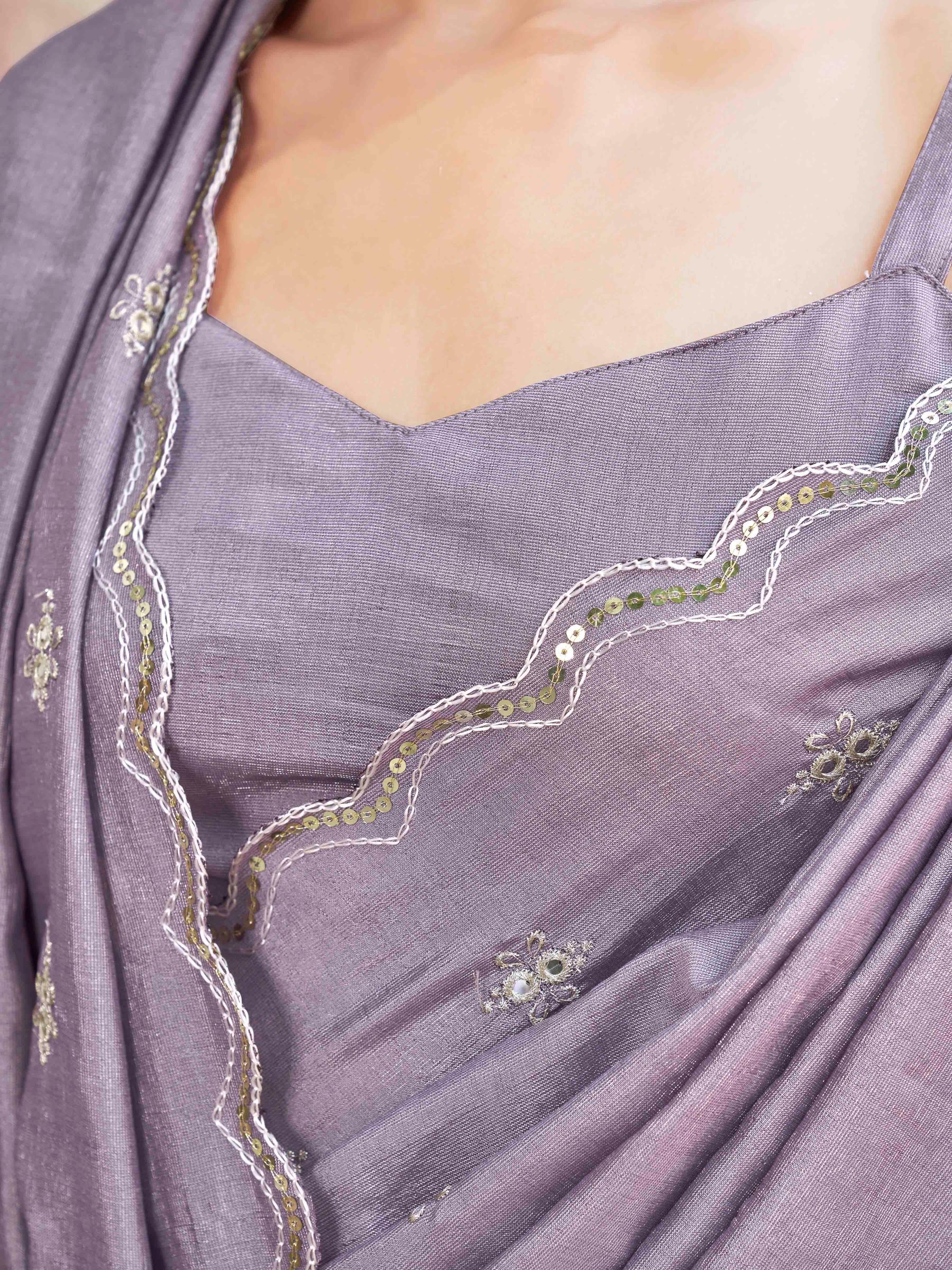 mauve colored saree with mirror embroidery on pallu and scalloped border