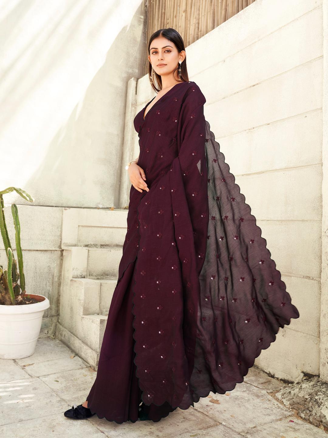 maroon colored saree with mirror embroidery on pallu and scalloped border