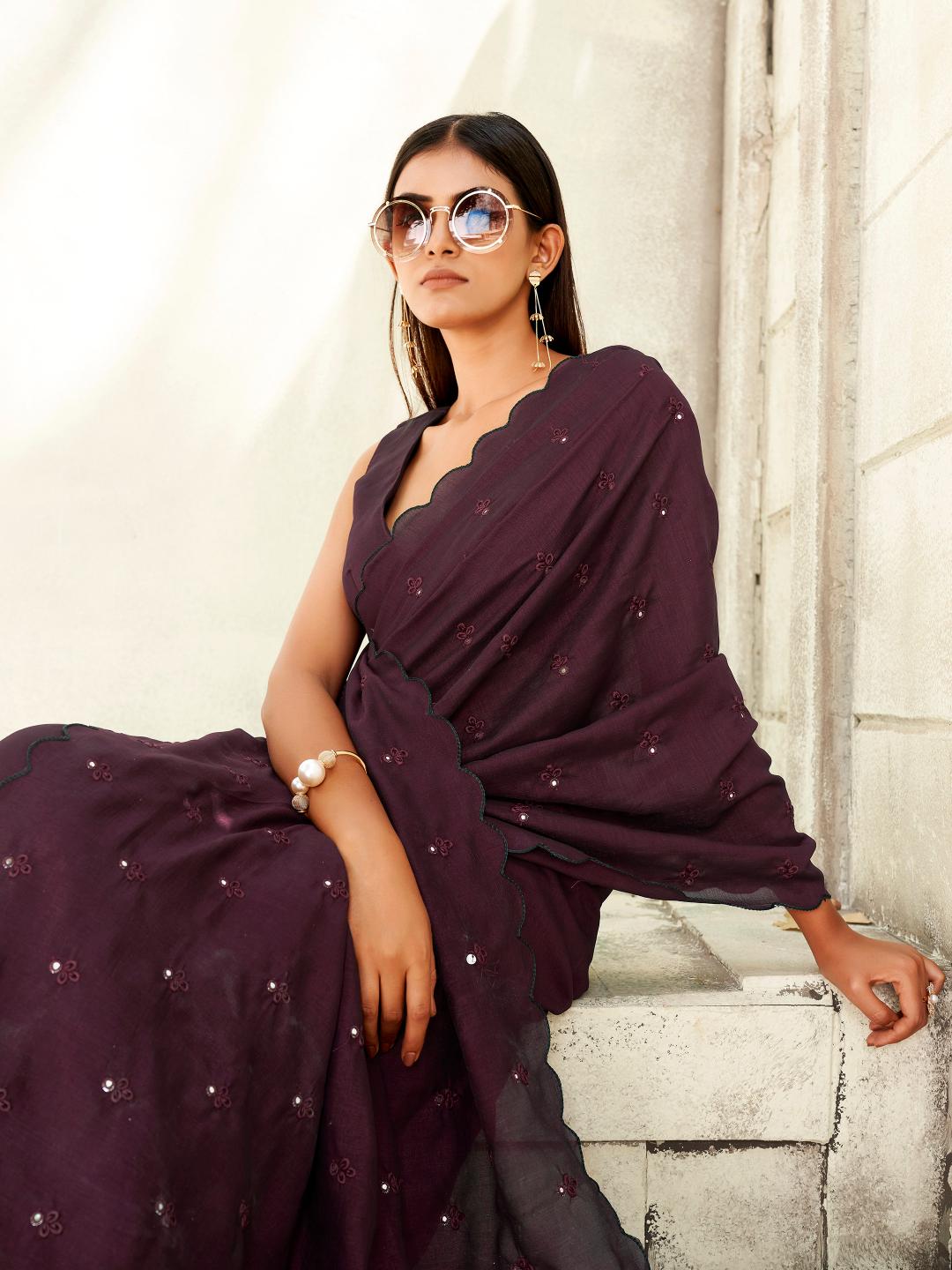 maroon colored saree with mirror embroidery on pallu and scalloped border