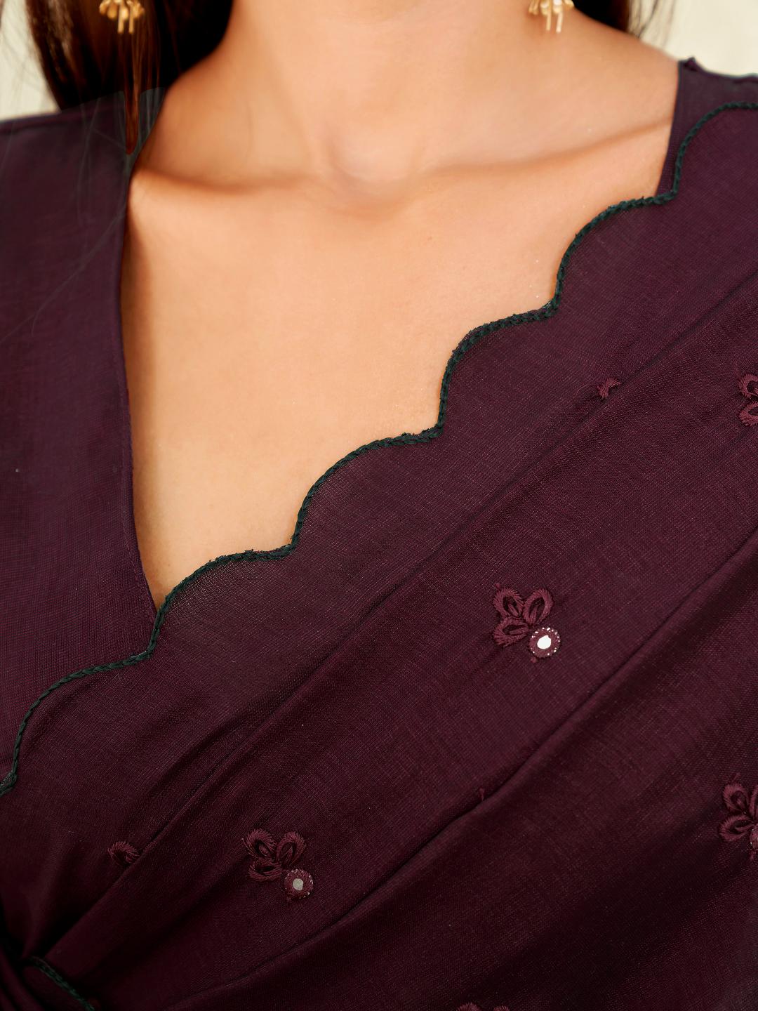 maroon colored saree with mirror embroidery on pallu and scalloped border